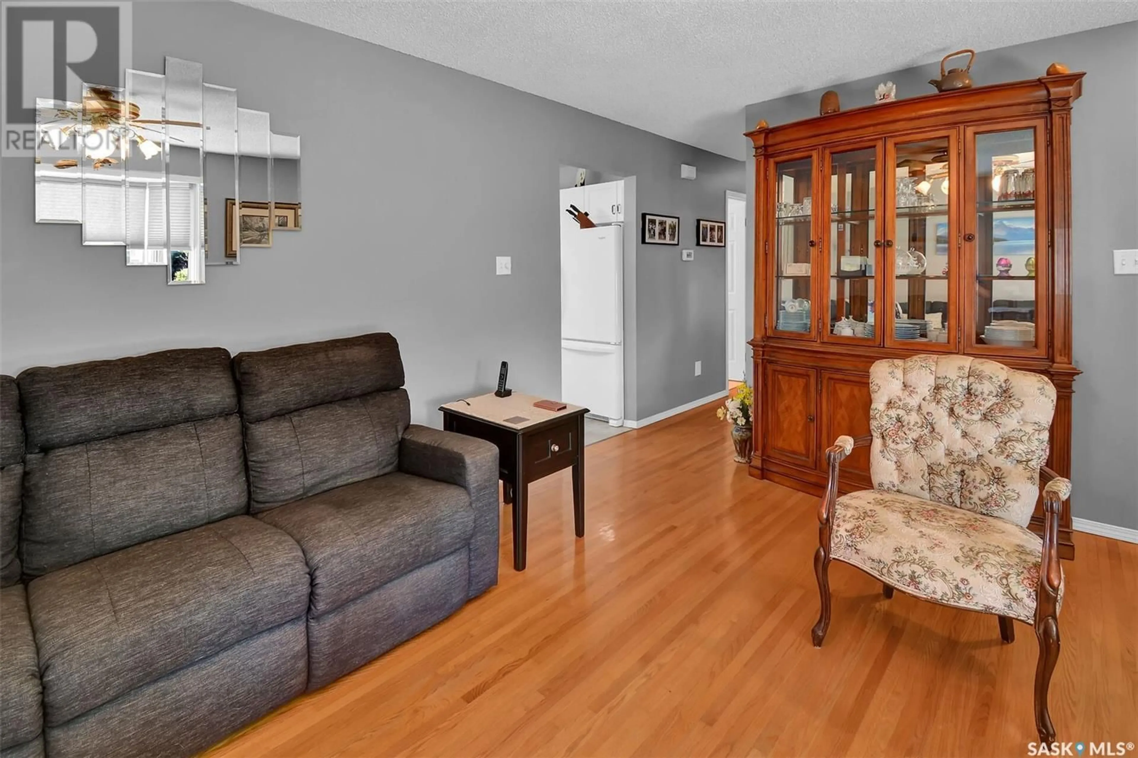 Living room with furniture, wood/laminate floor for 2106 37TH STREET, Saskatoon Saskatchewan S7L4S3