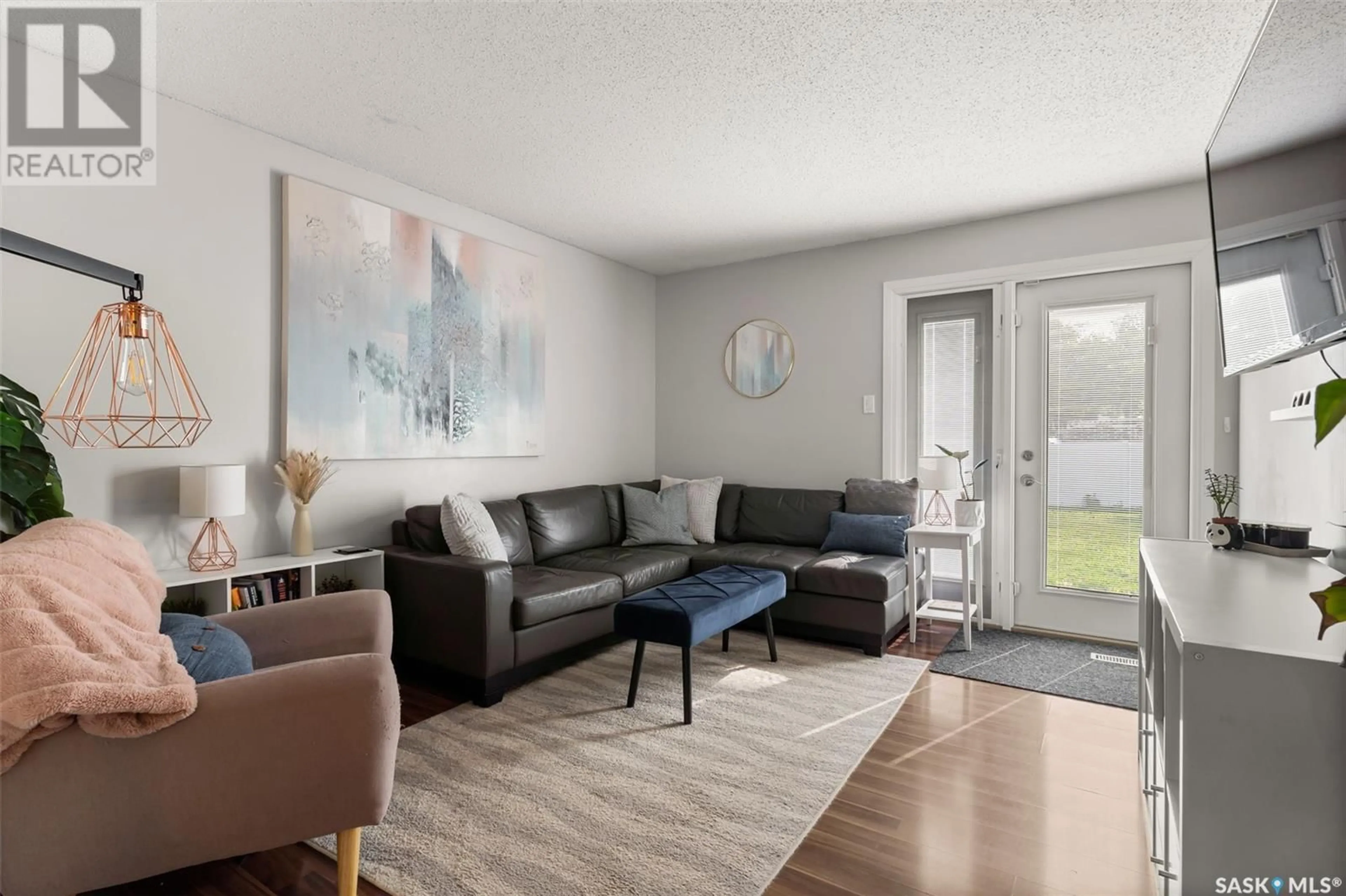 Living room with furniture, wood/laminate floor for 807 VANIER DRIVE, Regina Saskatchewan S4X2K9