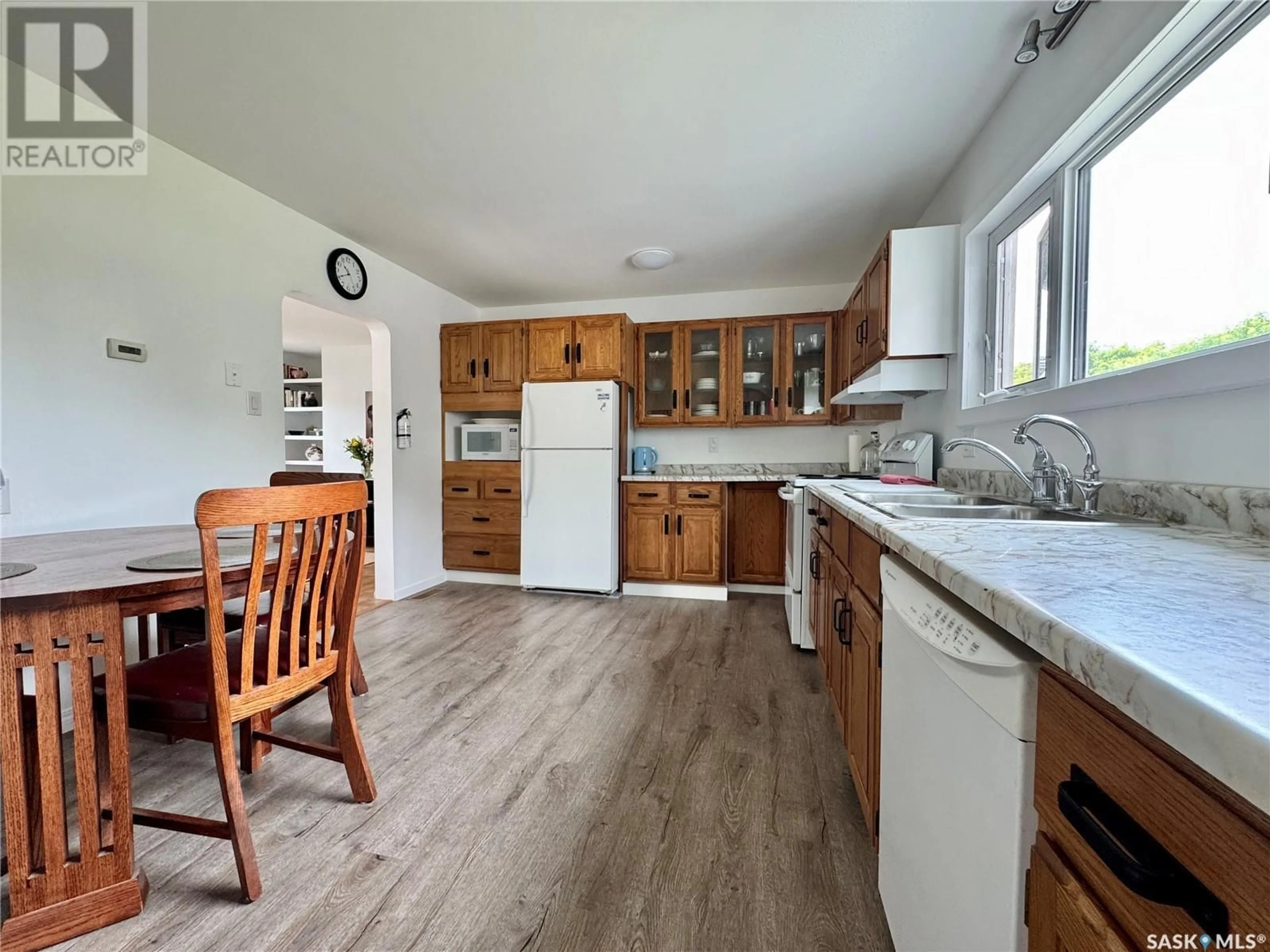 Open concept kitchen, wood/laminate floor for 306 ANGUS PLACE, Stockholm Saskatchewan S0A3Y0