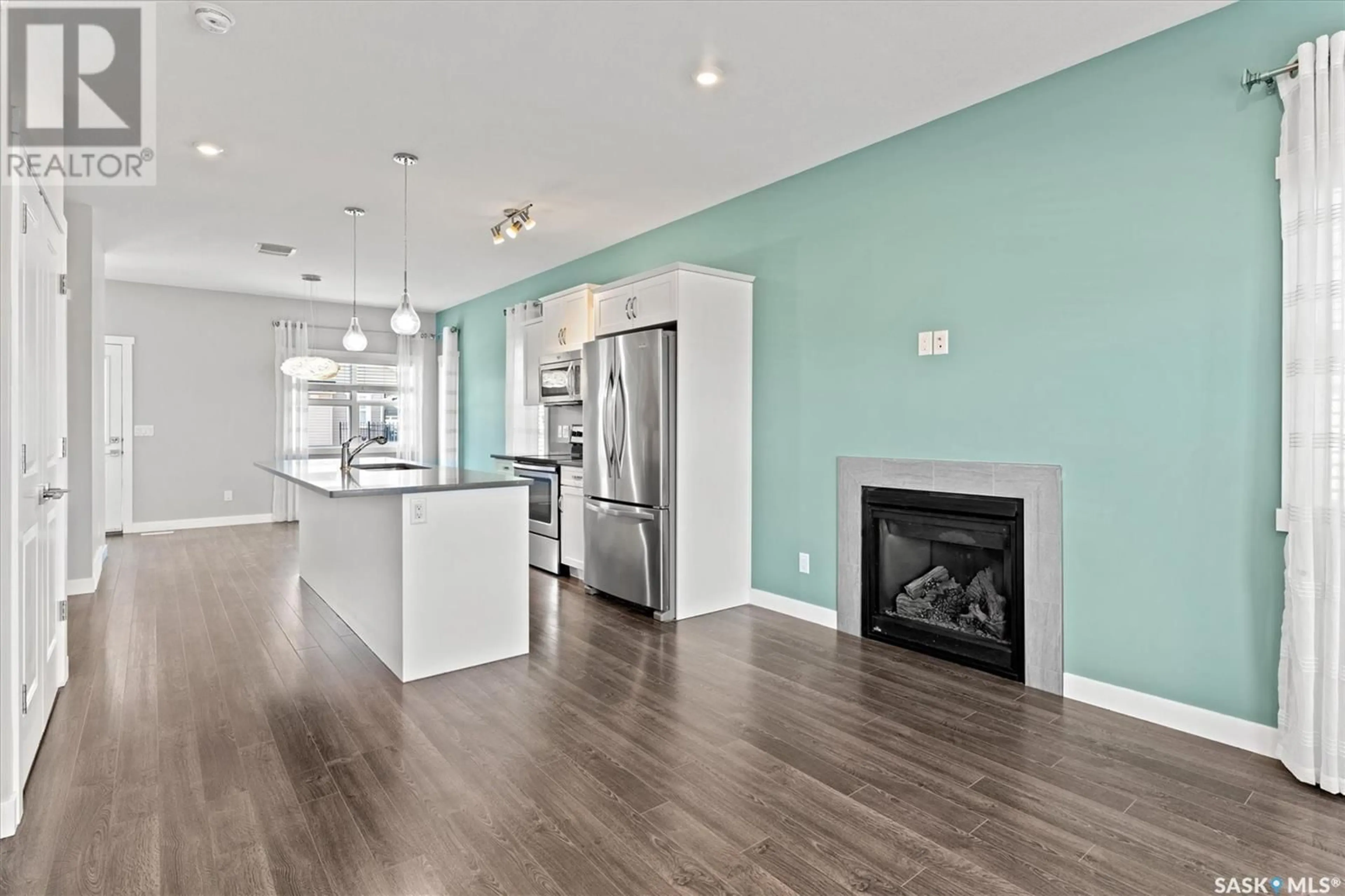 Open concept kitchen, wood/laminate floor for 1137 KOLYNCHUK LINK, Saskatoon Saskatchewan S7T0X5