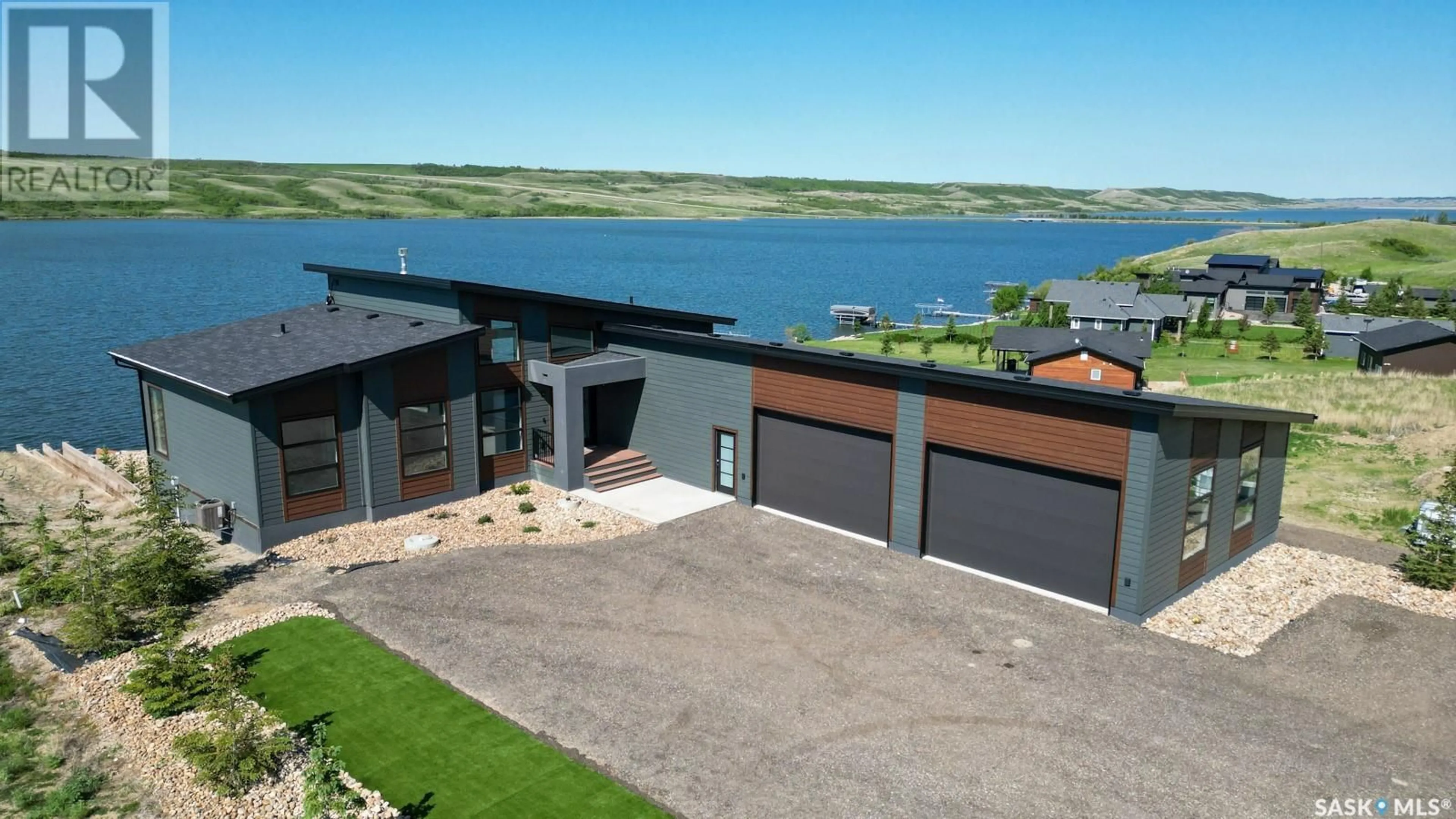 A pic from outside/outdoor area/front of a property/back of a property/a pic from drone, water/lake/river/ocean view for 12 SUNSET BOULEVARD, North Grove Saskatchewan S0G0P0