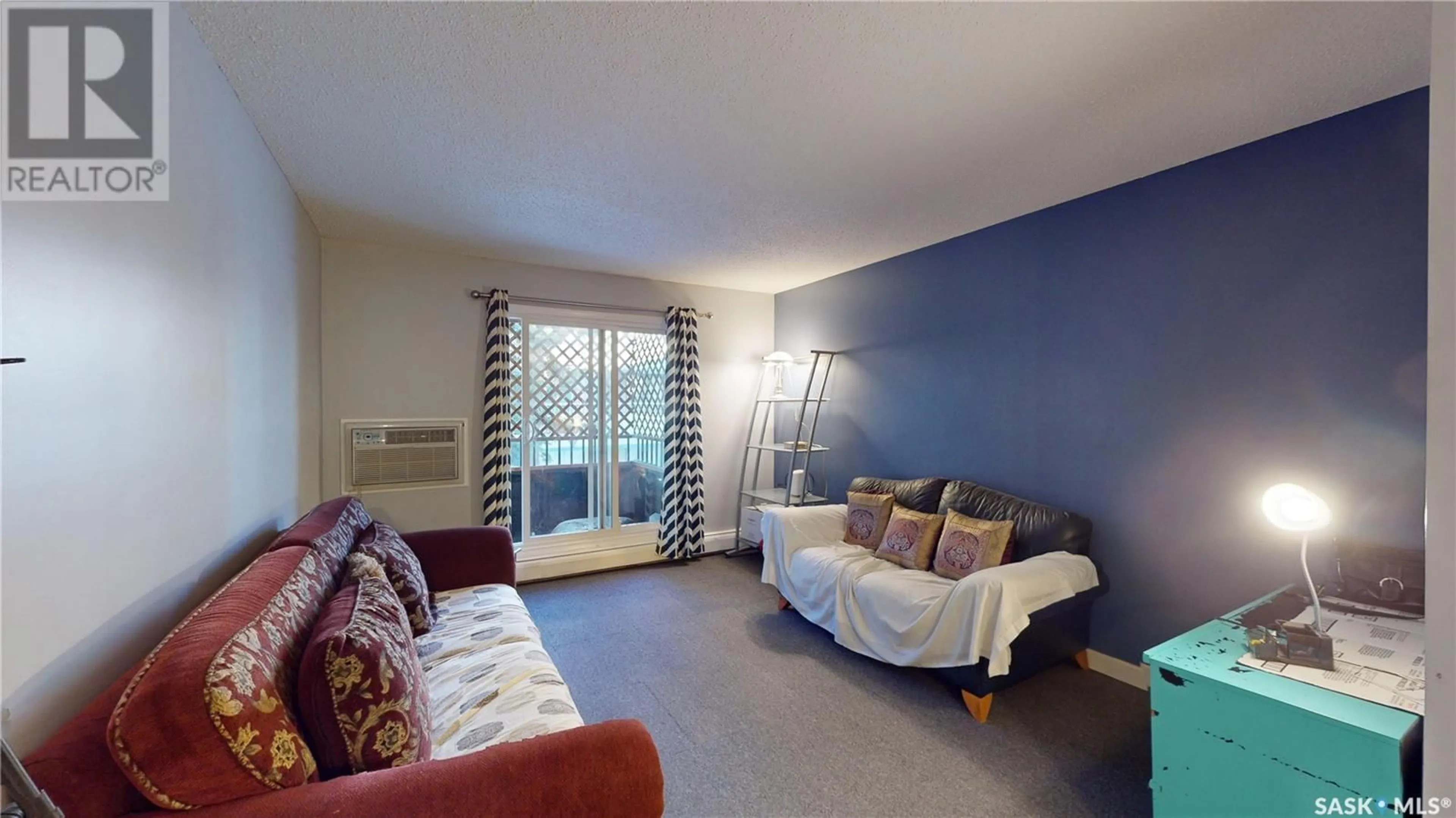 Living room with furniture, wood/laminate floor for 203 - 601 X AVENUE, Saskatoon Saskatchewan S7M4R7