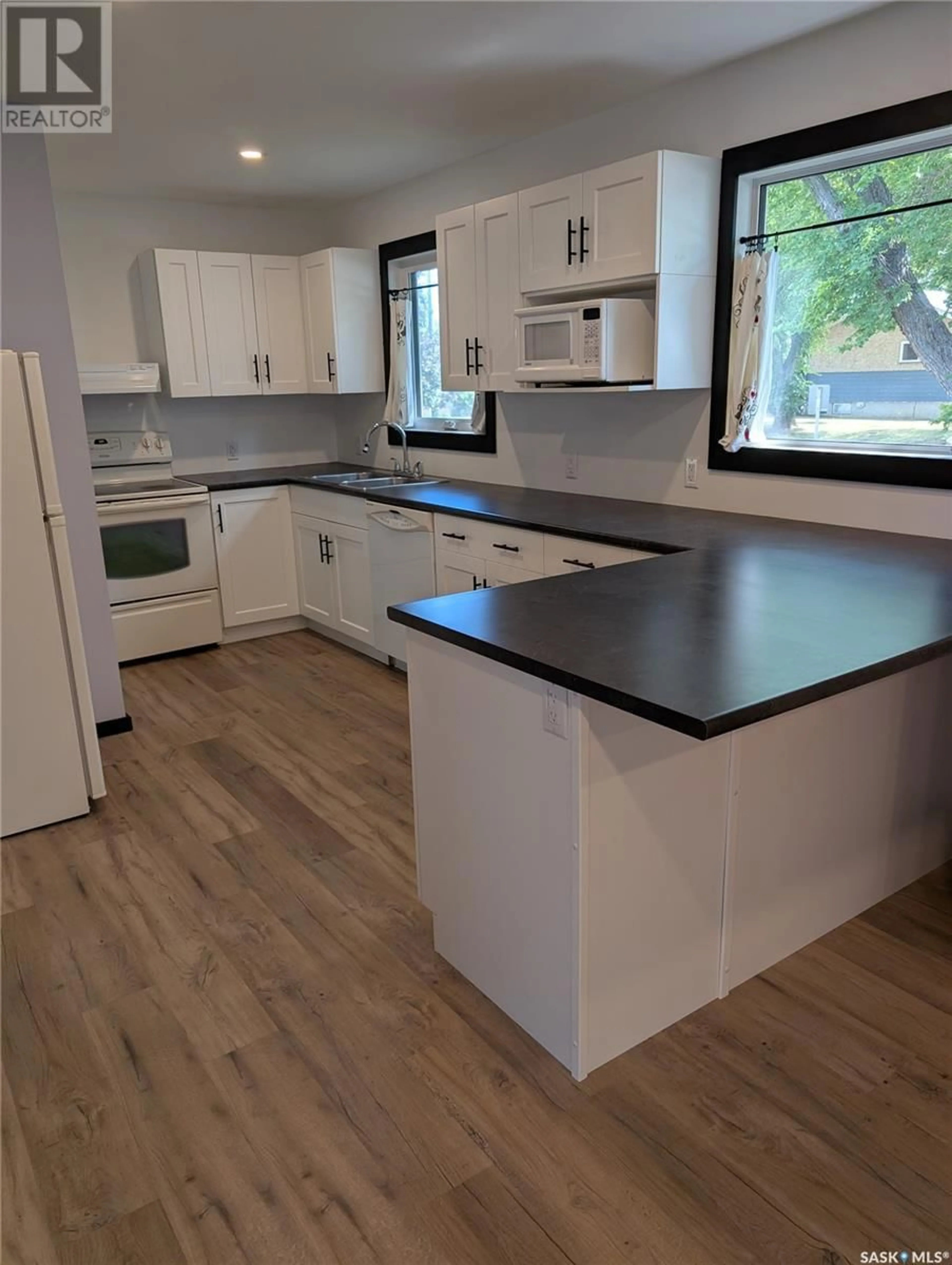 Open concept kitchen, wood/laminate floor for 330 25TH STREET, Prince Albert Saskatchewan S6V1T1