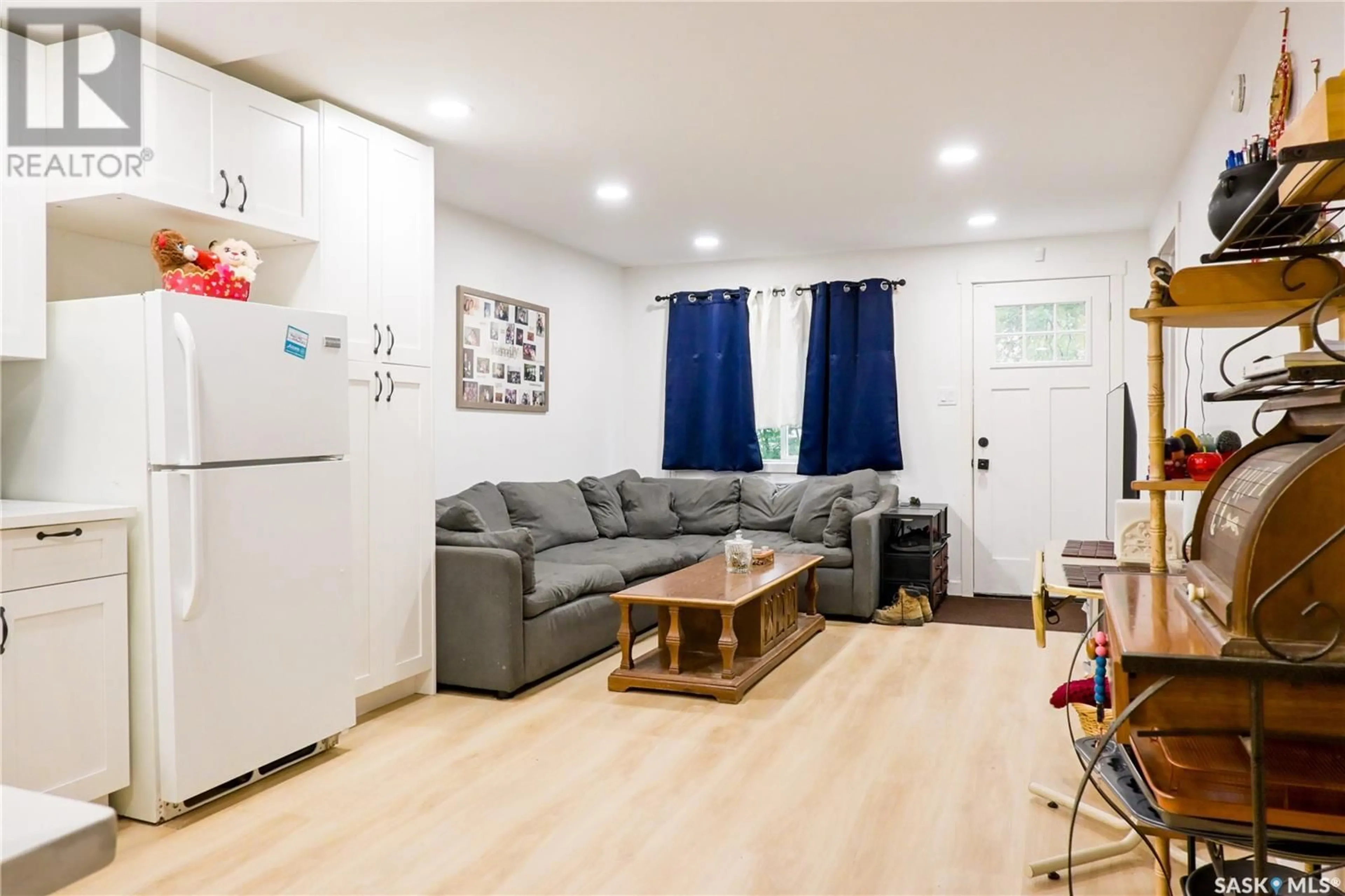 Living room with furniture, wood/laminate floor for 693 RETALLACK STREET, Regina Saskatchewan S4T2G5