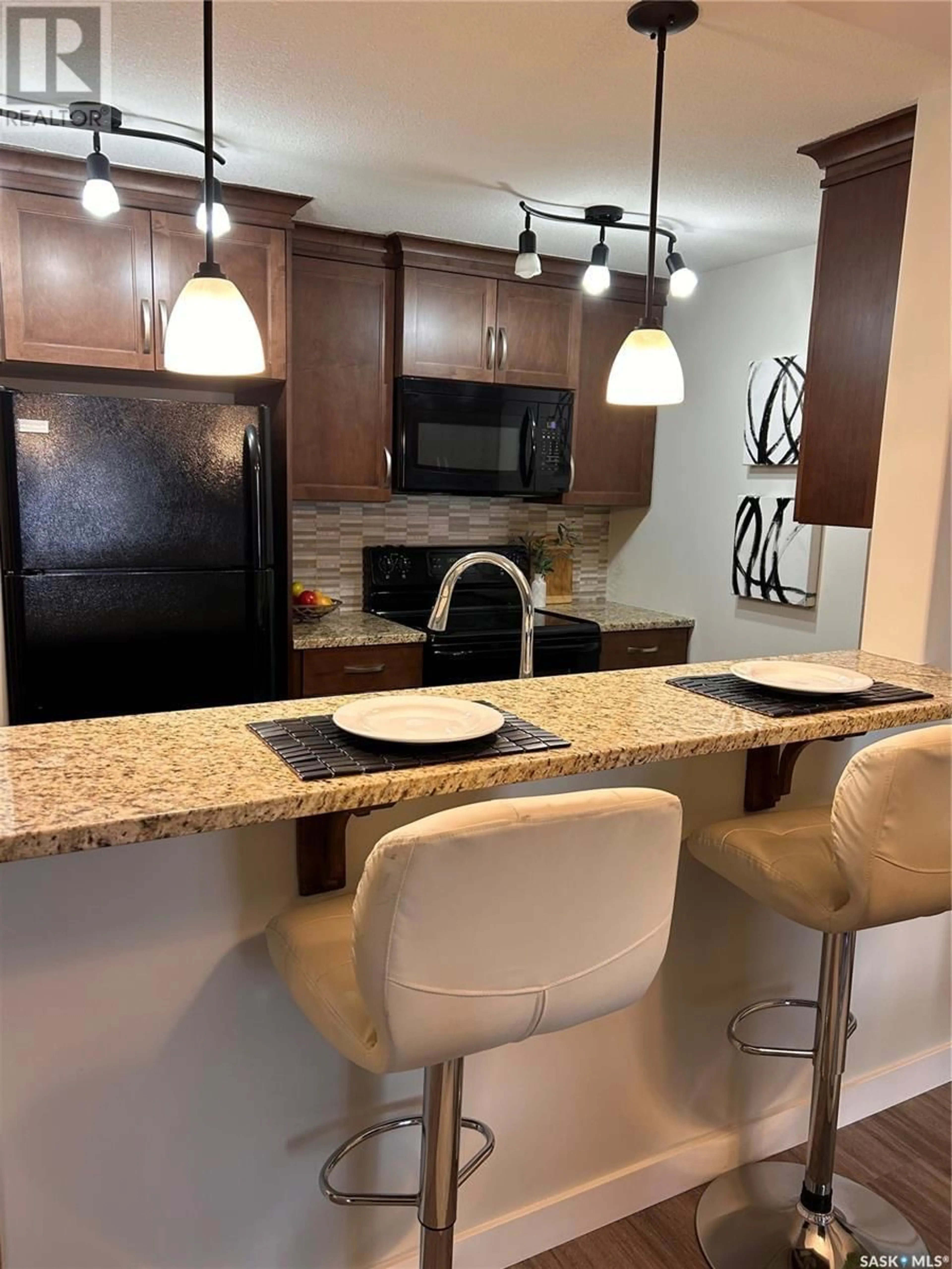 Open concept kitchen, ceramic/tile floor for 102 - 1220 BLACKFOOT DRIVE, Regina Saskatchewan S4S6T2