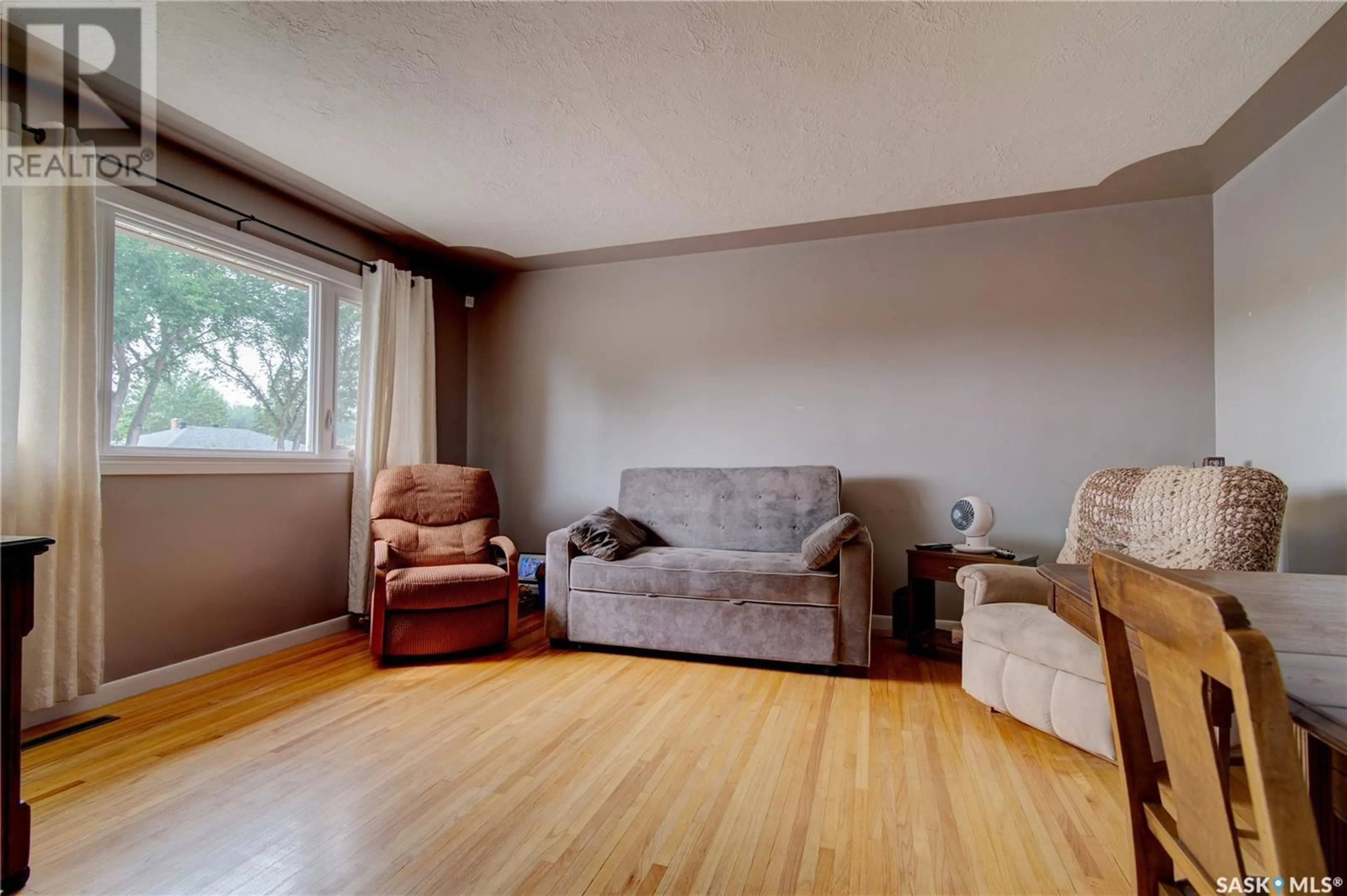 Living room with furniture, wood/laminate floor for 1033 HORACE STREET, Regina Saskatchewan S4T5L3
