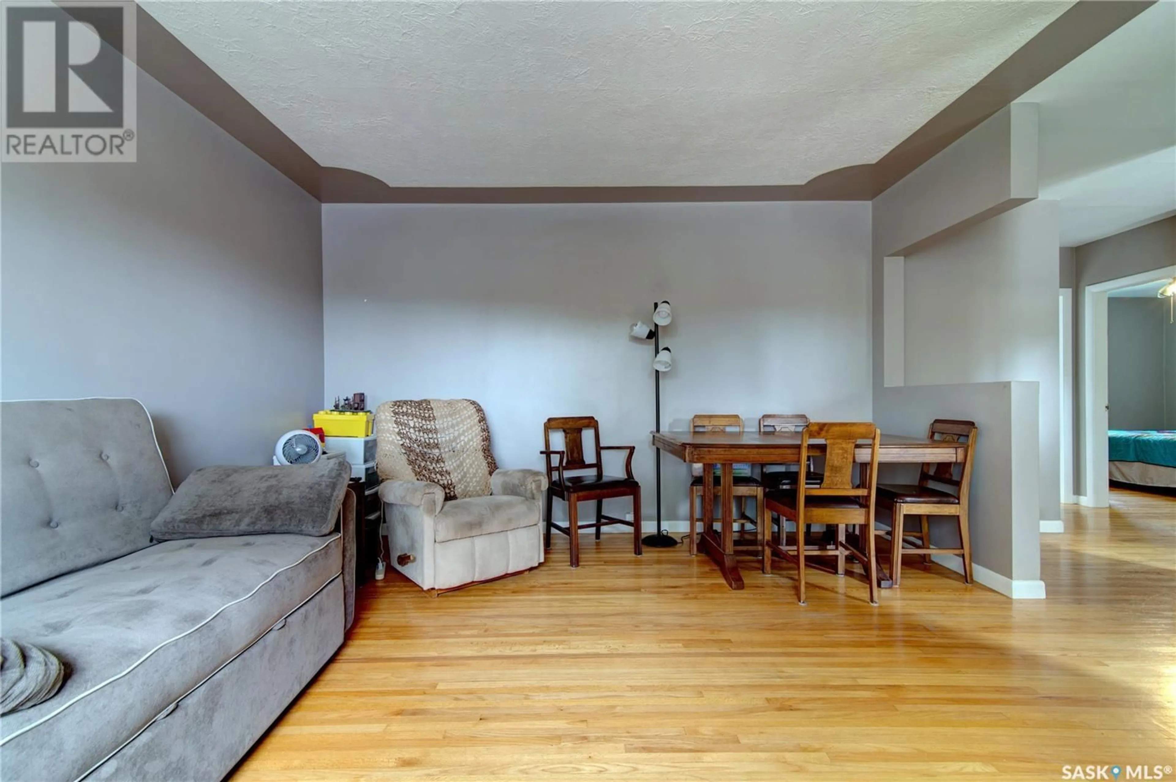 Living room with furniture, wood/laminate floor for 1033 HORACE STREET, Regina Saskatchewan S4T5L3