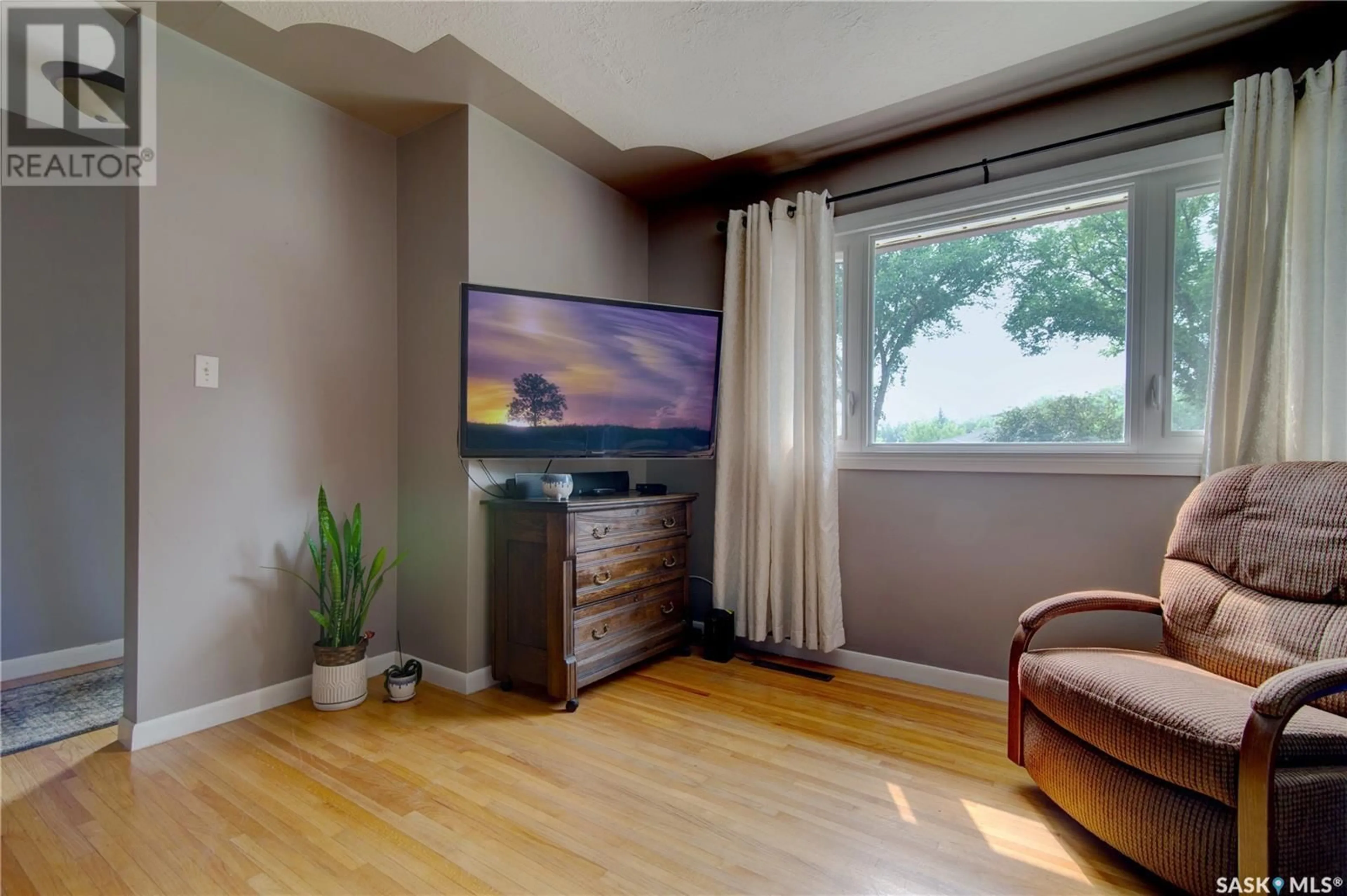 Living room with furniture, wood/laminate floor for 1033 HORACE STREET, Regina Saskatchewan S4T5L3