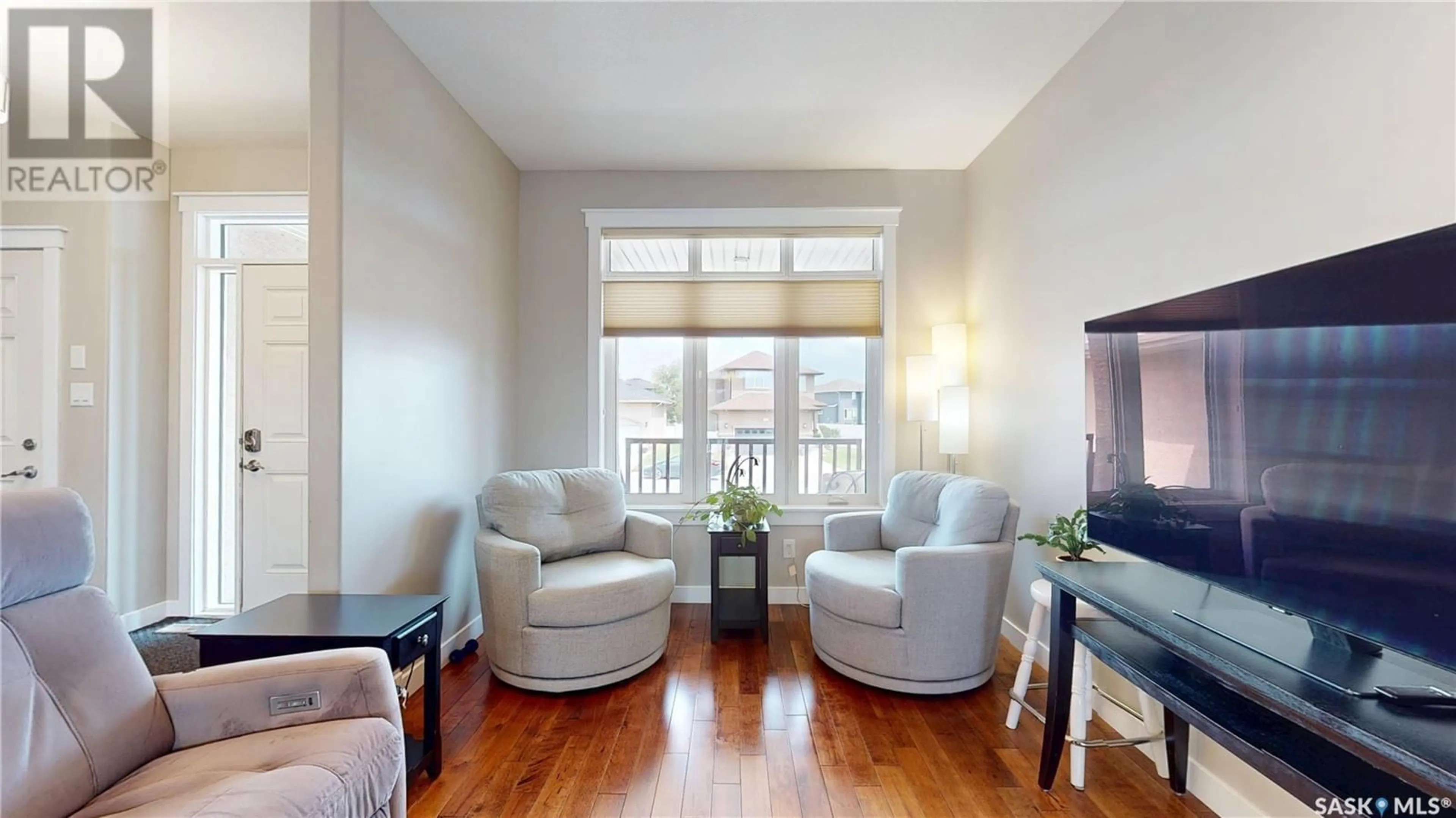 Living room with furniture, wood/laminate floor for 1806 BLAKE ROAD, Regina Saskatchewan S4X0G5