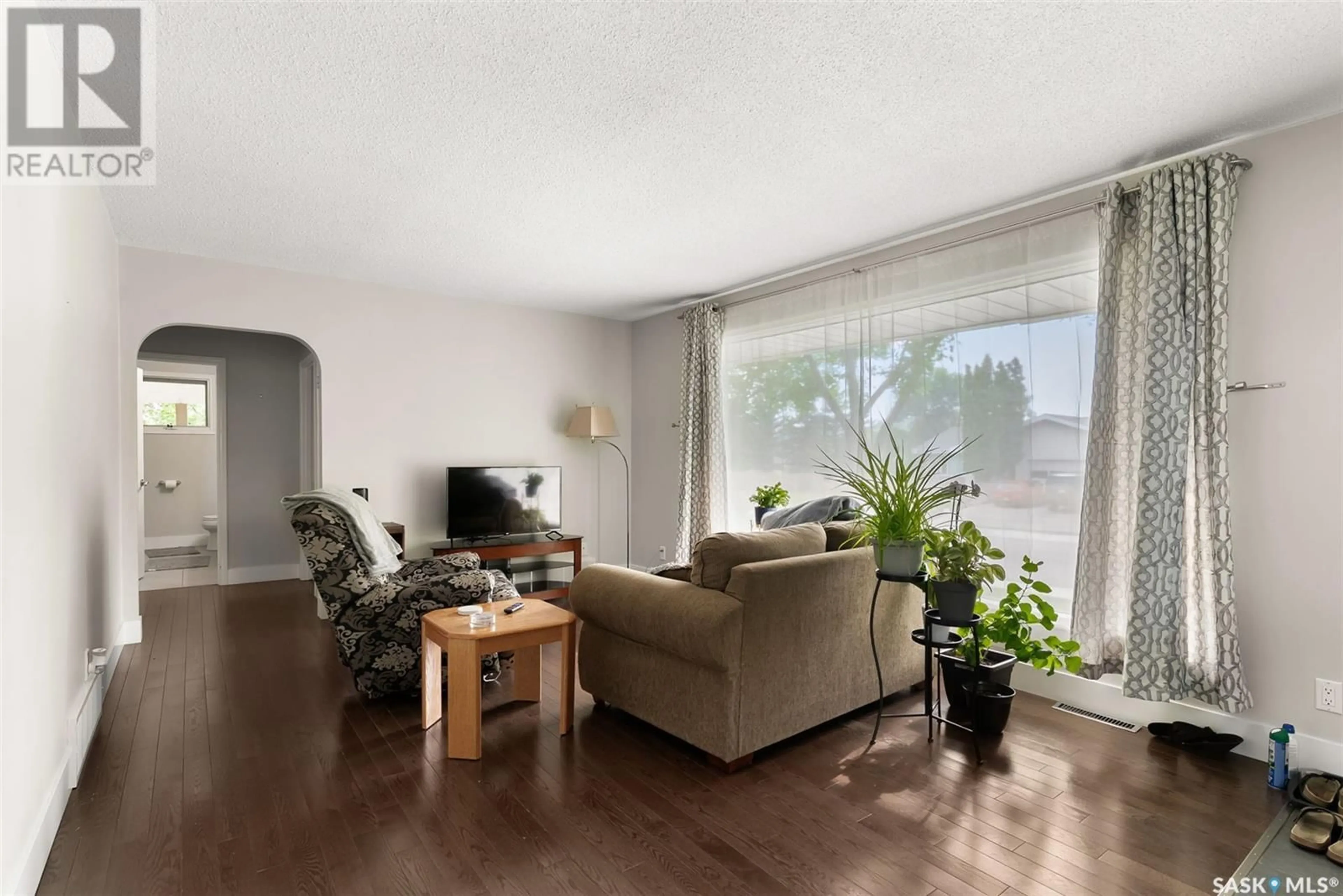 Living room with furniture, wood/laminate floor for 3347 QUEEN STREET, Regina Saskatchewan S4S1B2