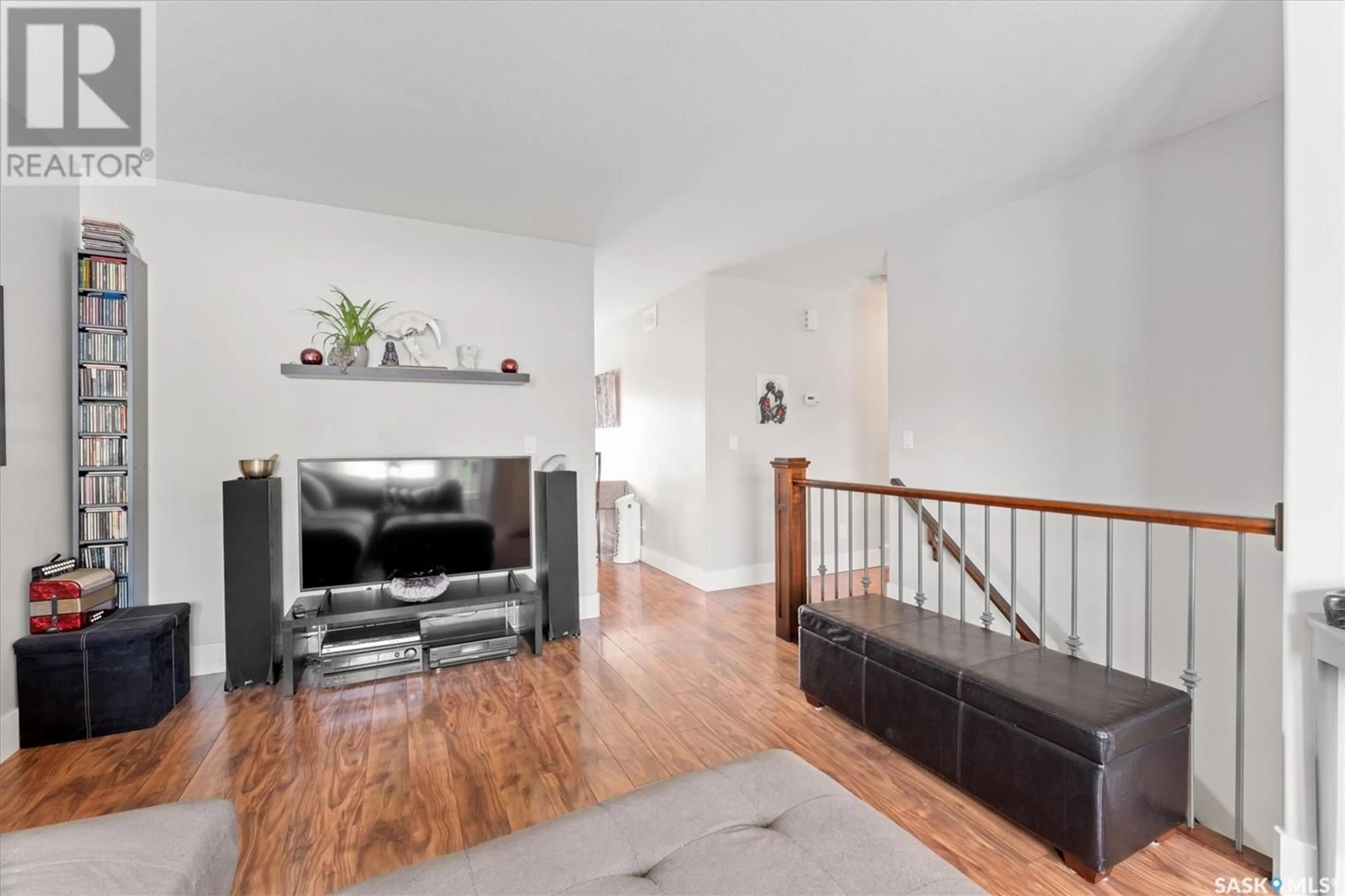 Living room with furniture, wood/laminate floor for 848 7TH STREET, Martensville Saskatchewan S0K2T1