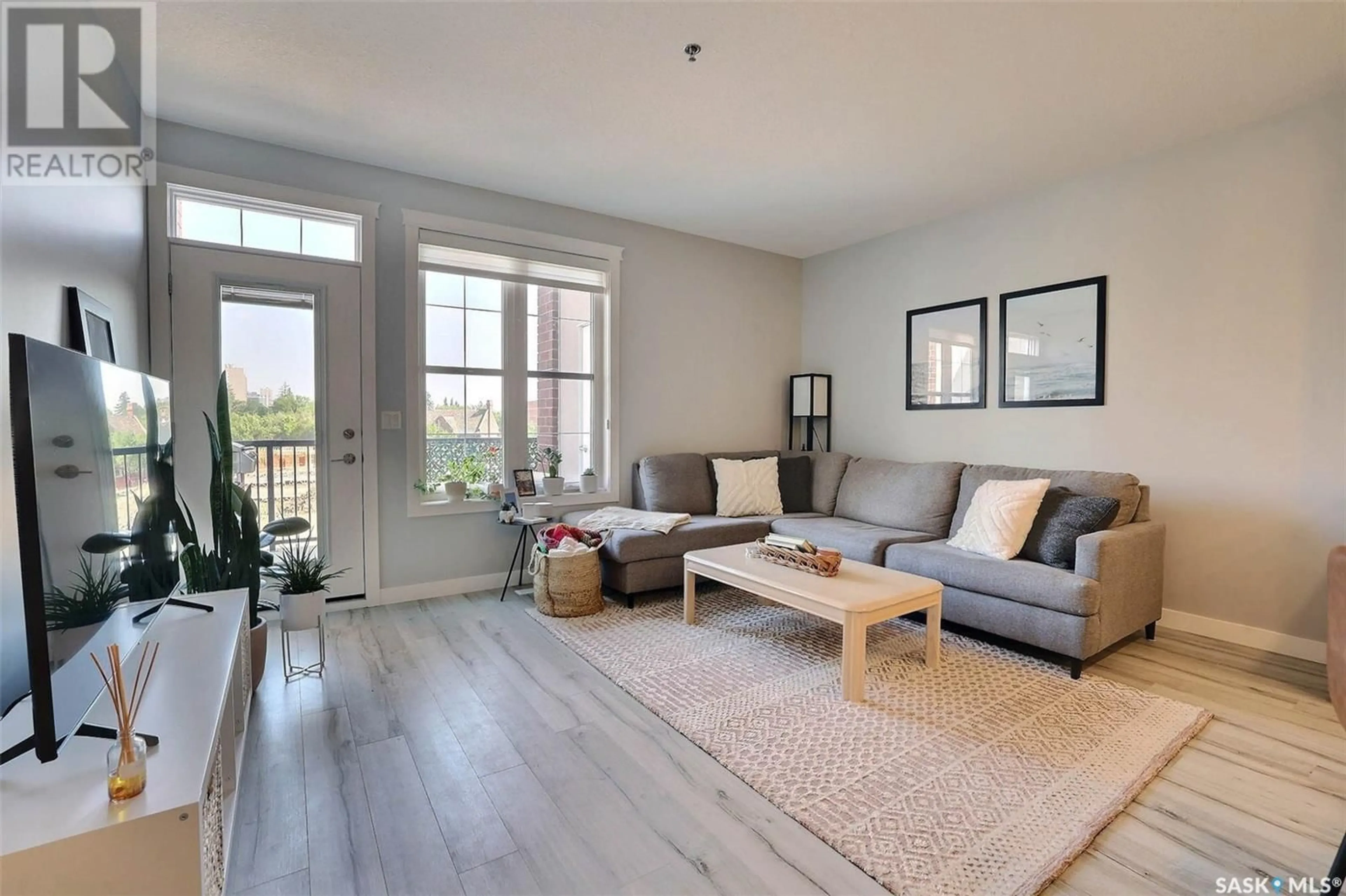 Living room with furniture, wood/laminate floor for 314 1700 BADHAM BOULEVARD, Regina Saskatchewan S4P0J7