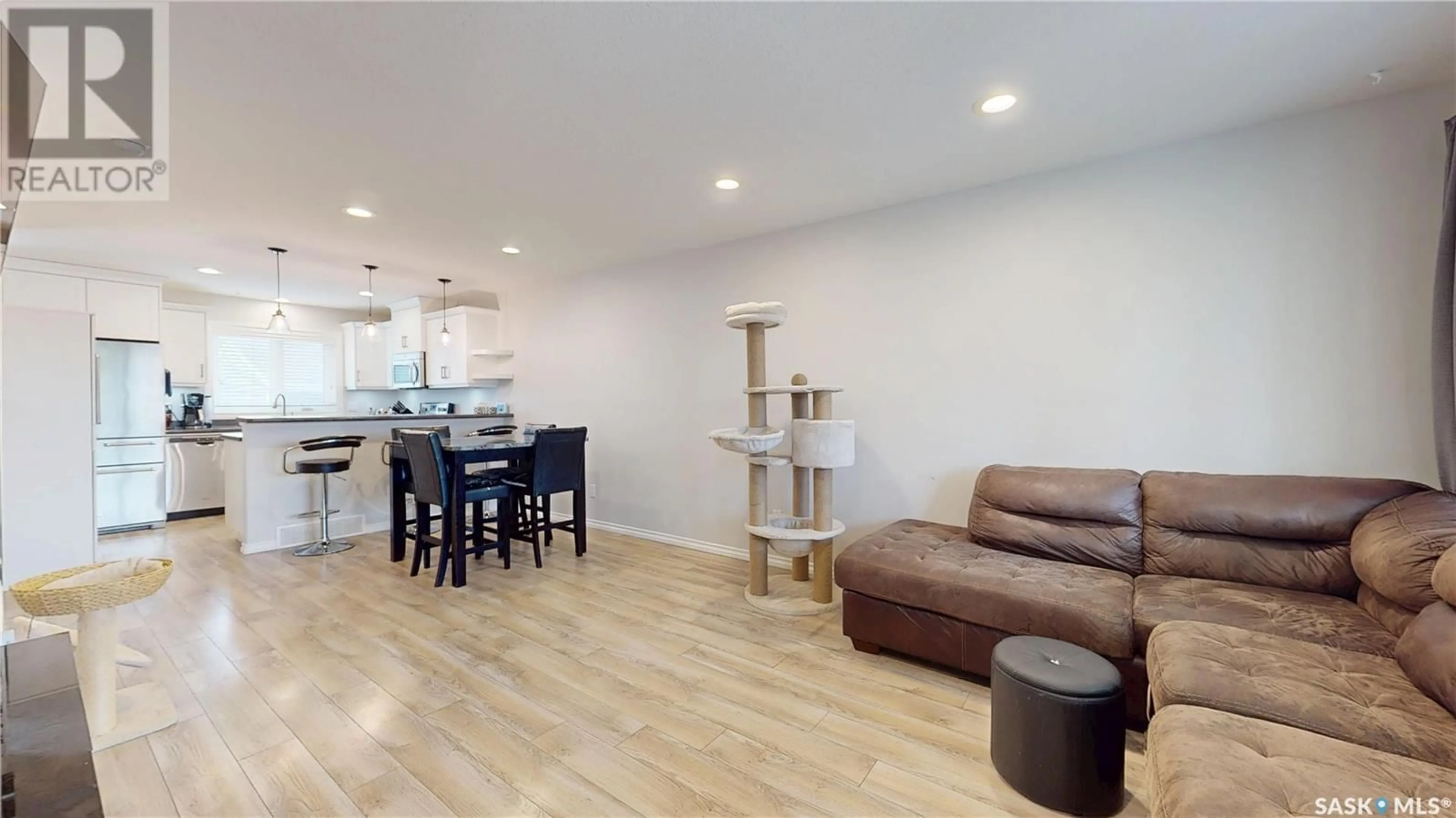 Living room with furniture, wood/laminate floor for 5625 CEDERHOLM AVENUE, Regina Saskatchewan S4W0M9
