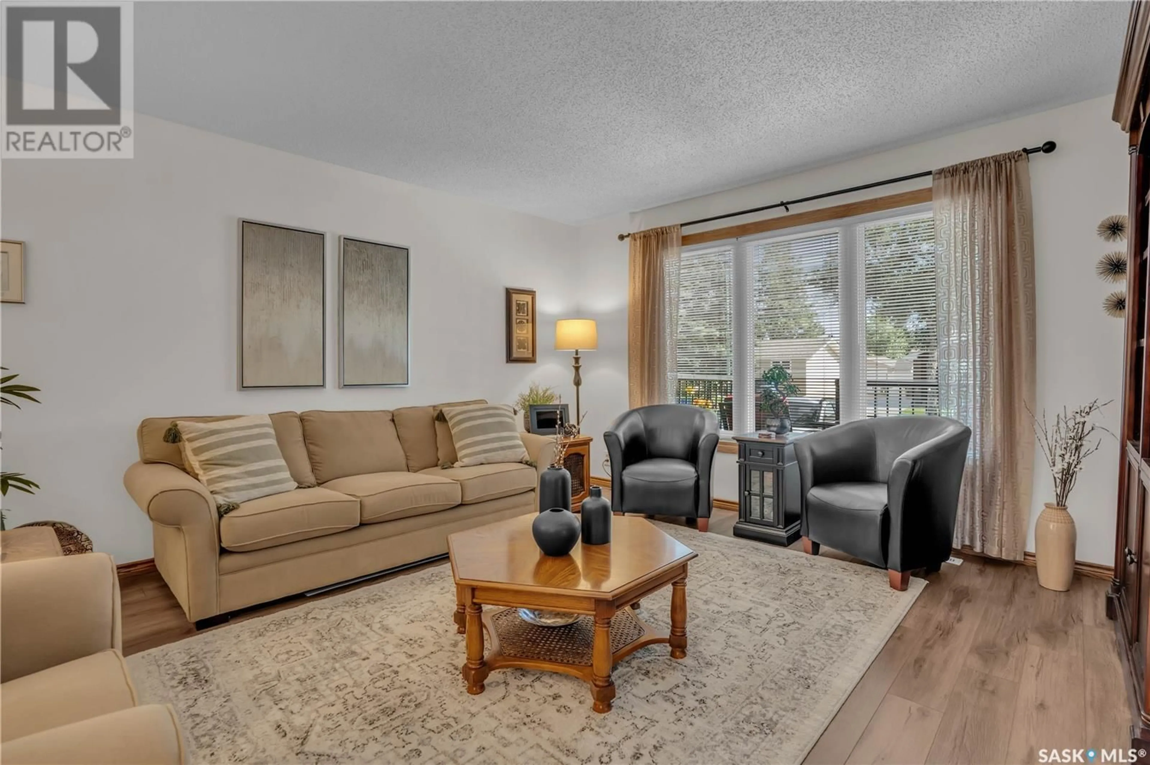 Living room with furniture, wood/laminate floor for 18 CATHERWOOD CRESCENT, Regina Saskatchewan S4R7A7