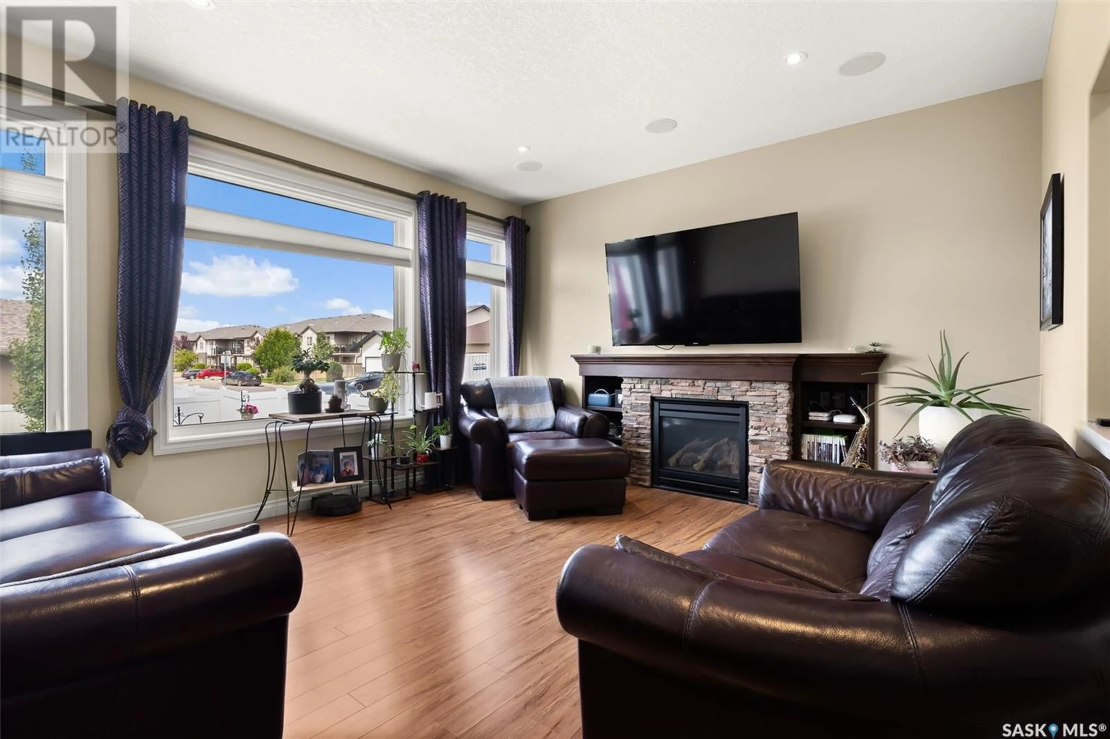 Living room with furniture, wood/laminate floor for 1834 BLAKE ROAD, Regina Saskatchewan S4X0G5
