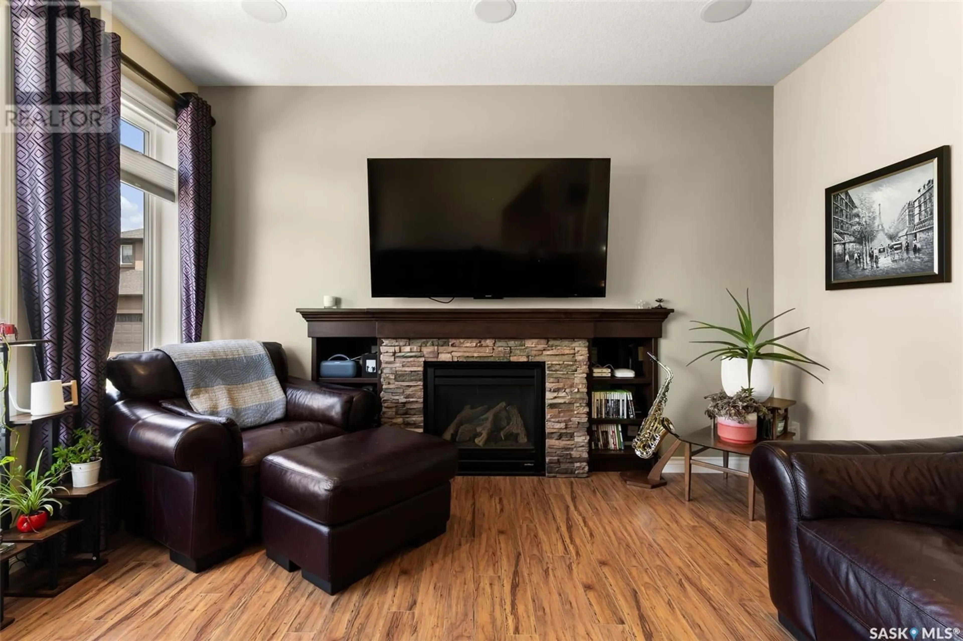 Living room with furniture, wood/laminate floor for 1834 BLAKE ROAD, Regina Saskatchewan S4X0G5
