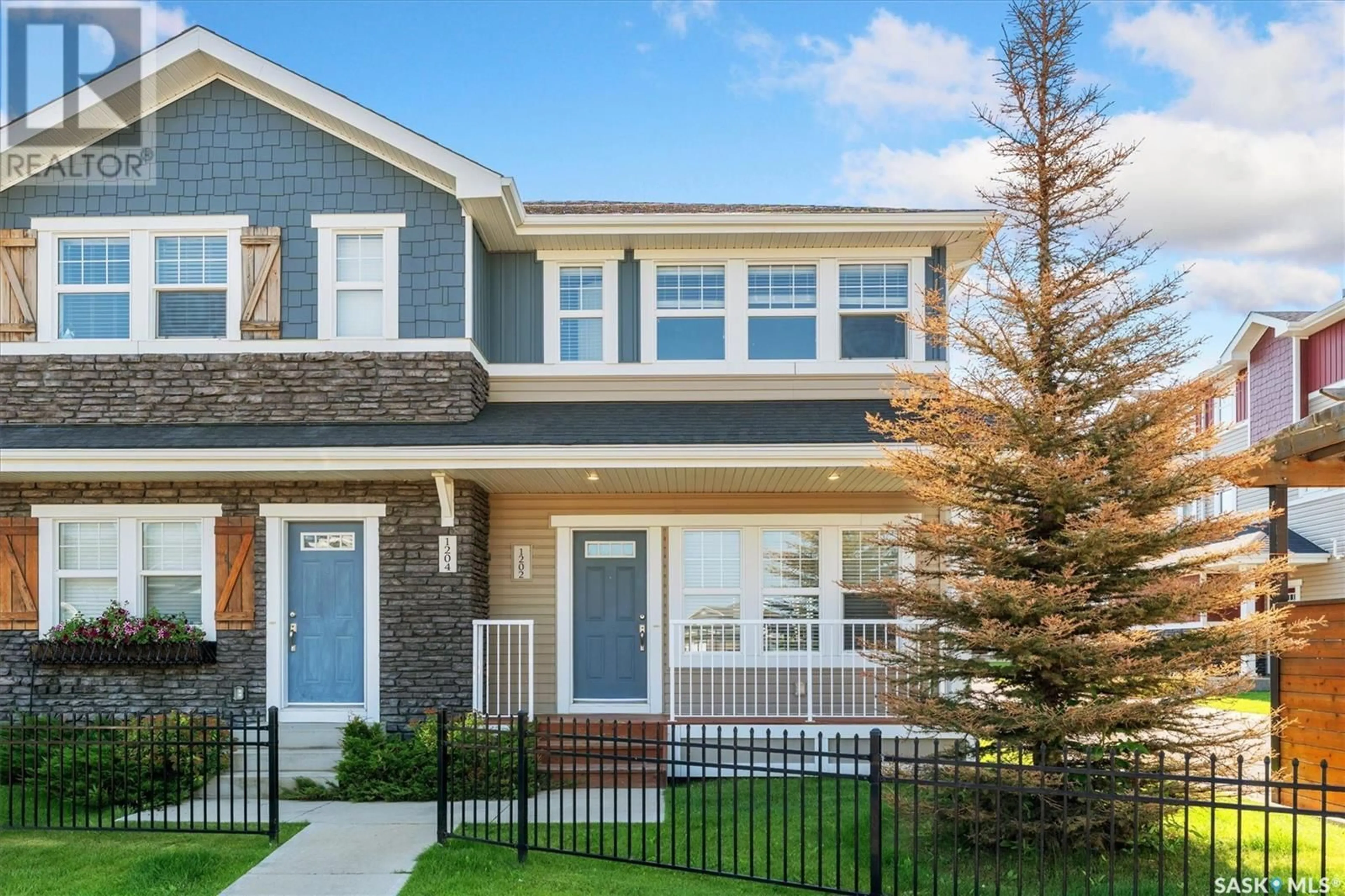 Home with vinyl exterior material, street for 1202 PRINGLE WAY, Saskatoon Saskatchewan S7T0X5