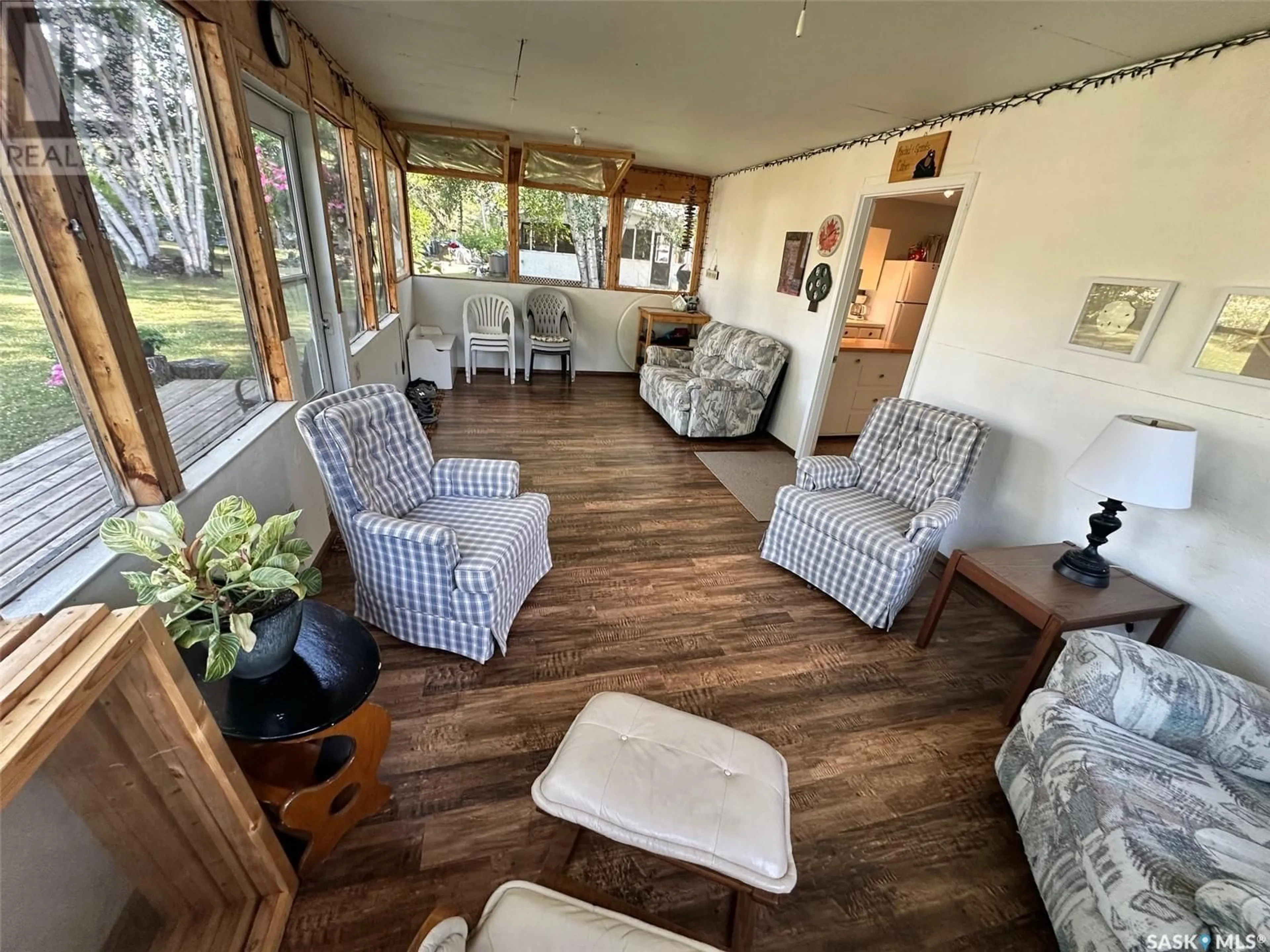 Living room with furniture, wood/laminate floor for 24 RUBY CRESCENT, Hudson Bay Saskatchewan S0E0E0