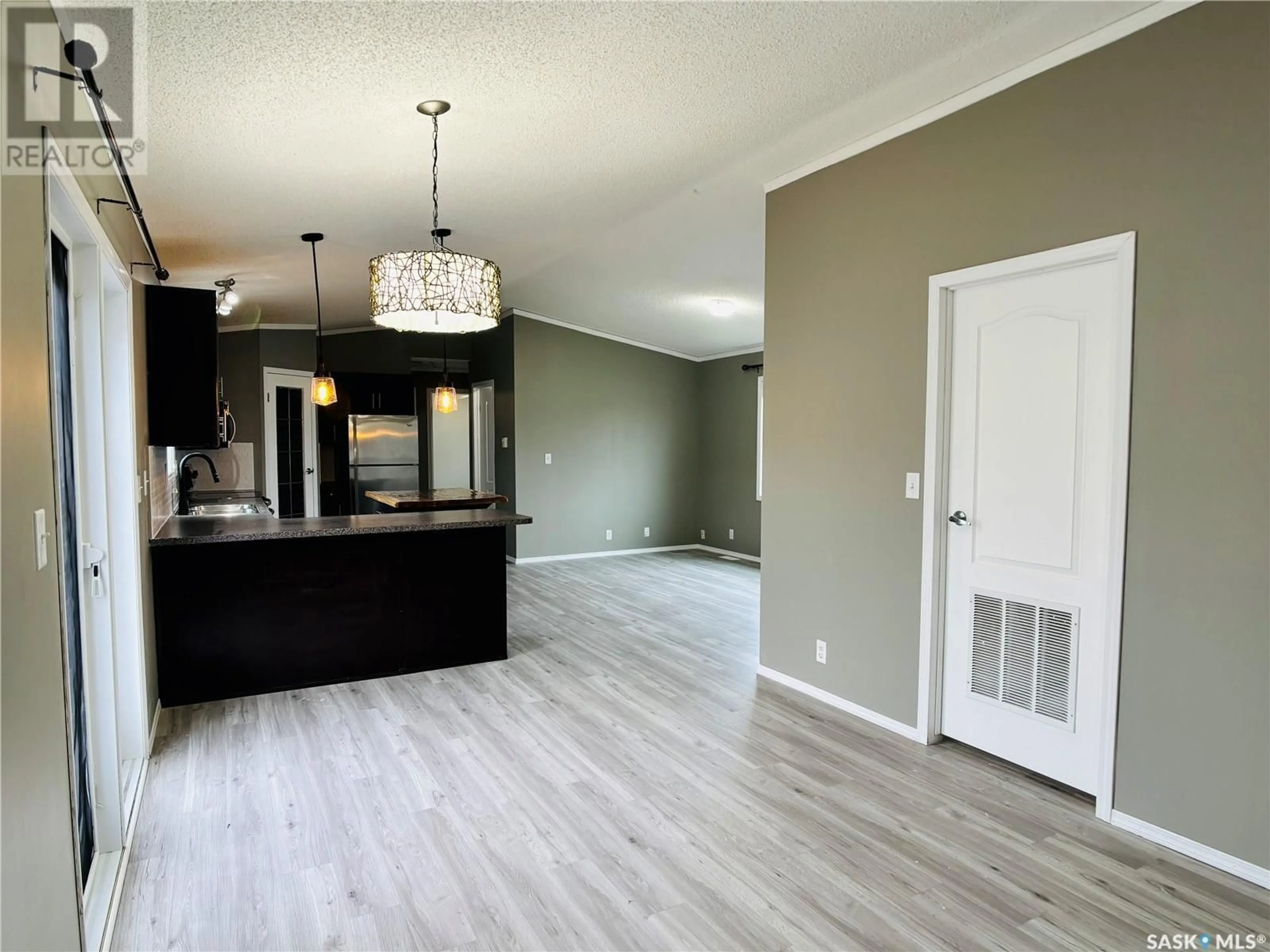 Open concept kitchen, wood/laminate floor for 18 2004 ALICE ROAD, Estevan Saskatchewan S4A3A7
