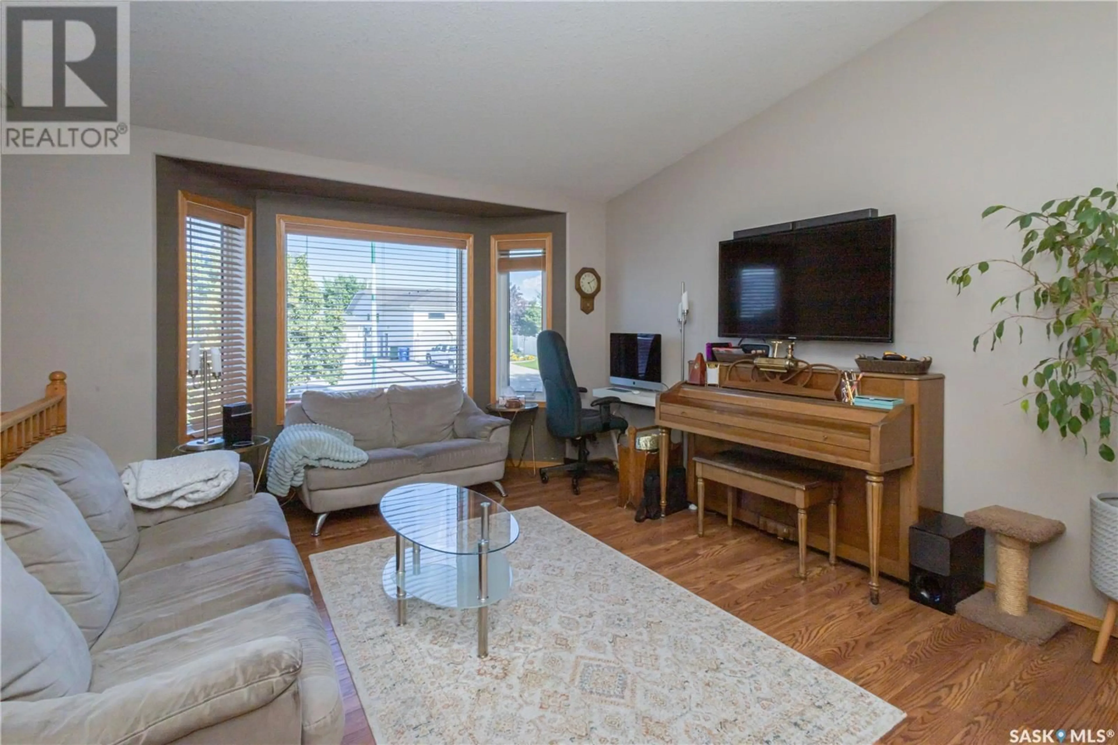 Living room with furniture, wood/laminate floor for 222 BEERLING CRESCENT, Saskatoon Saskatchewan S7S1K4