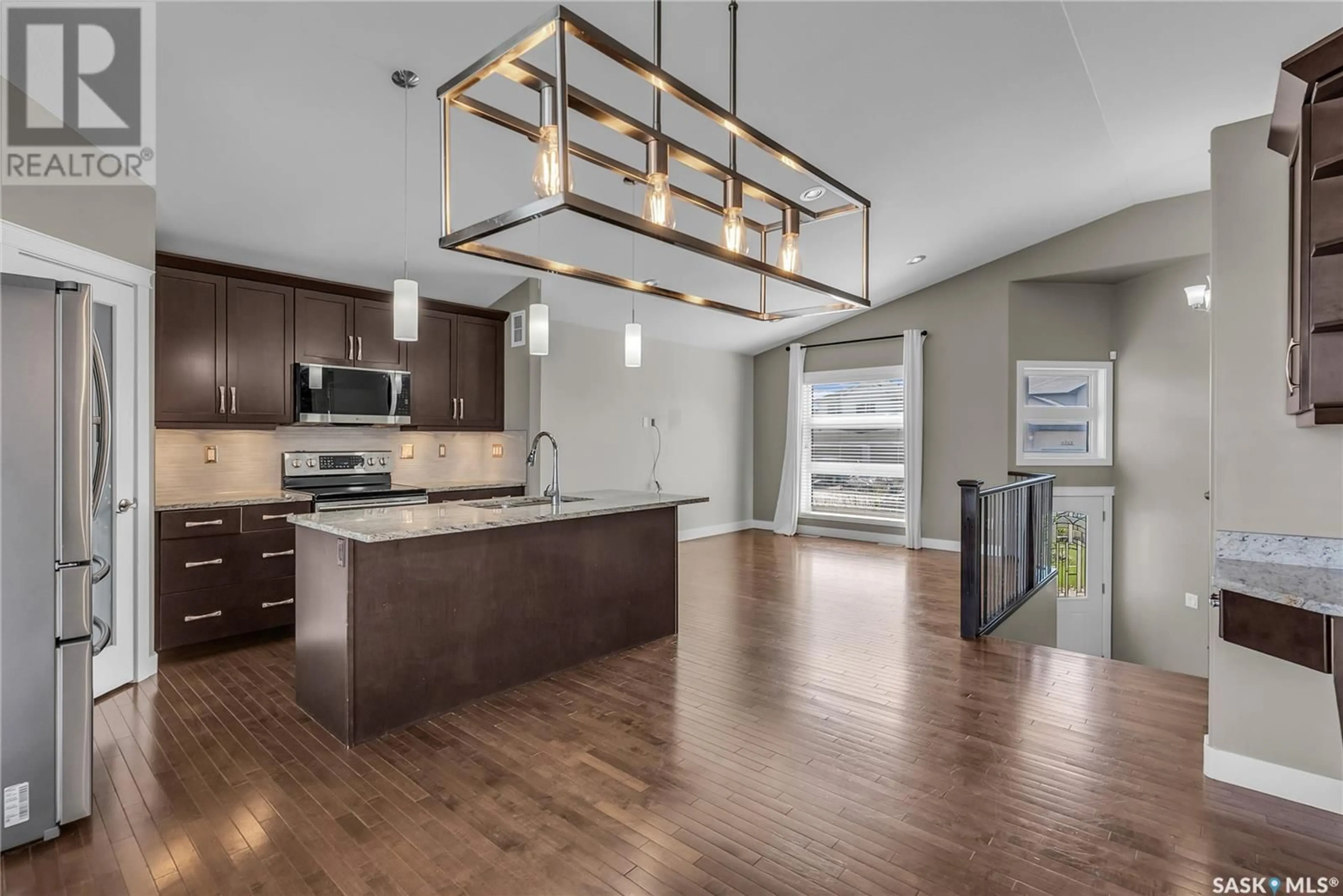 Open concept kitchen, wood/laminate floor for 447 MAHABIR CRESCENT, Saskatoon Saskatchewan S7W0J7