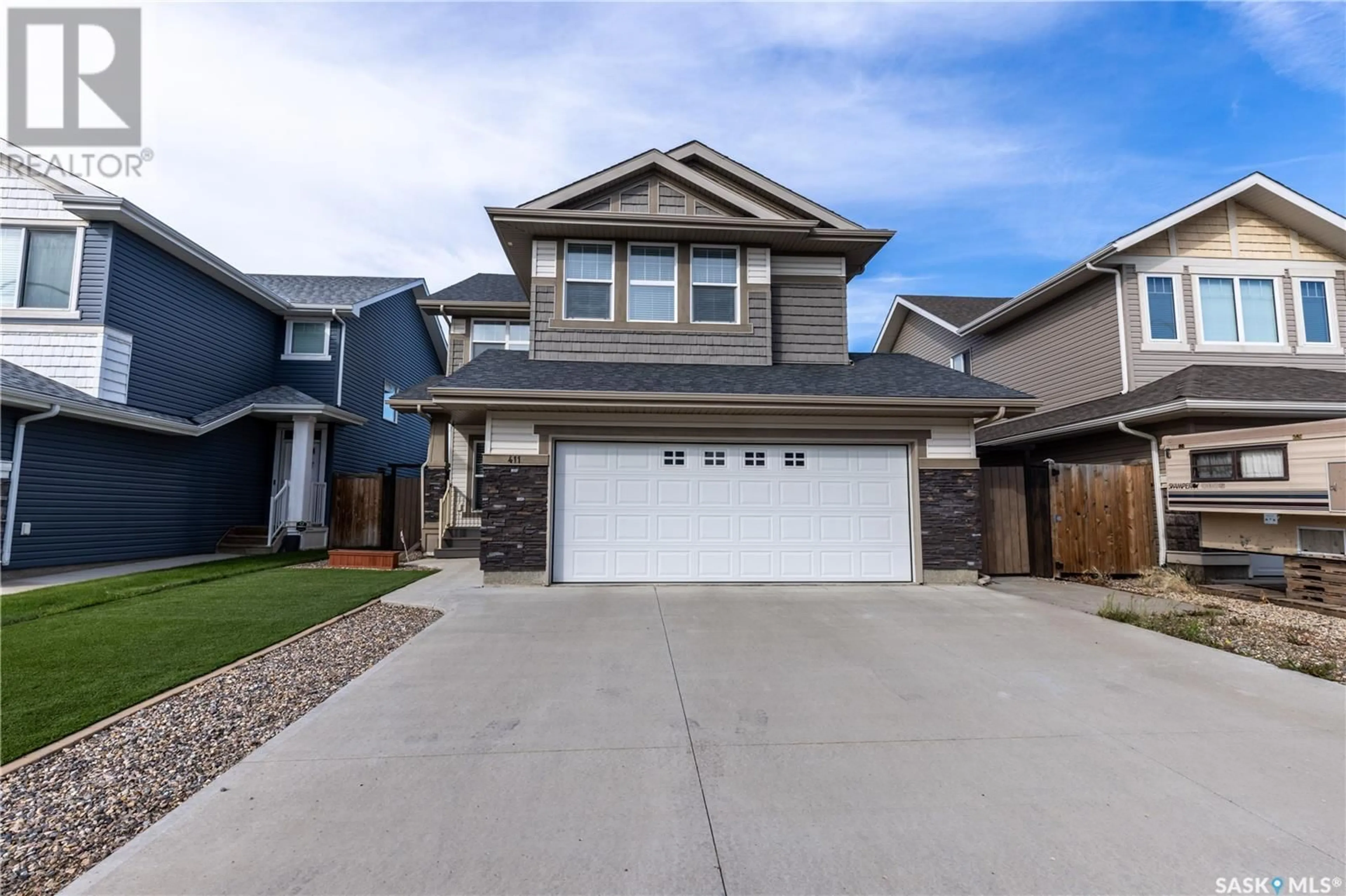 Home with vinyl exterior material, street for 411 FLYNN LANE, Saskatoon Saskatchewan S7V0L1