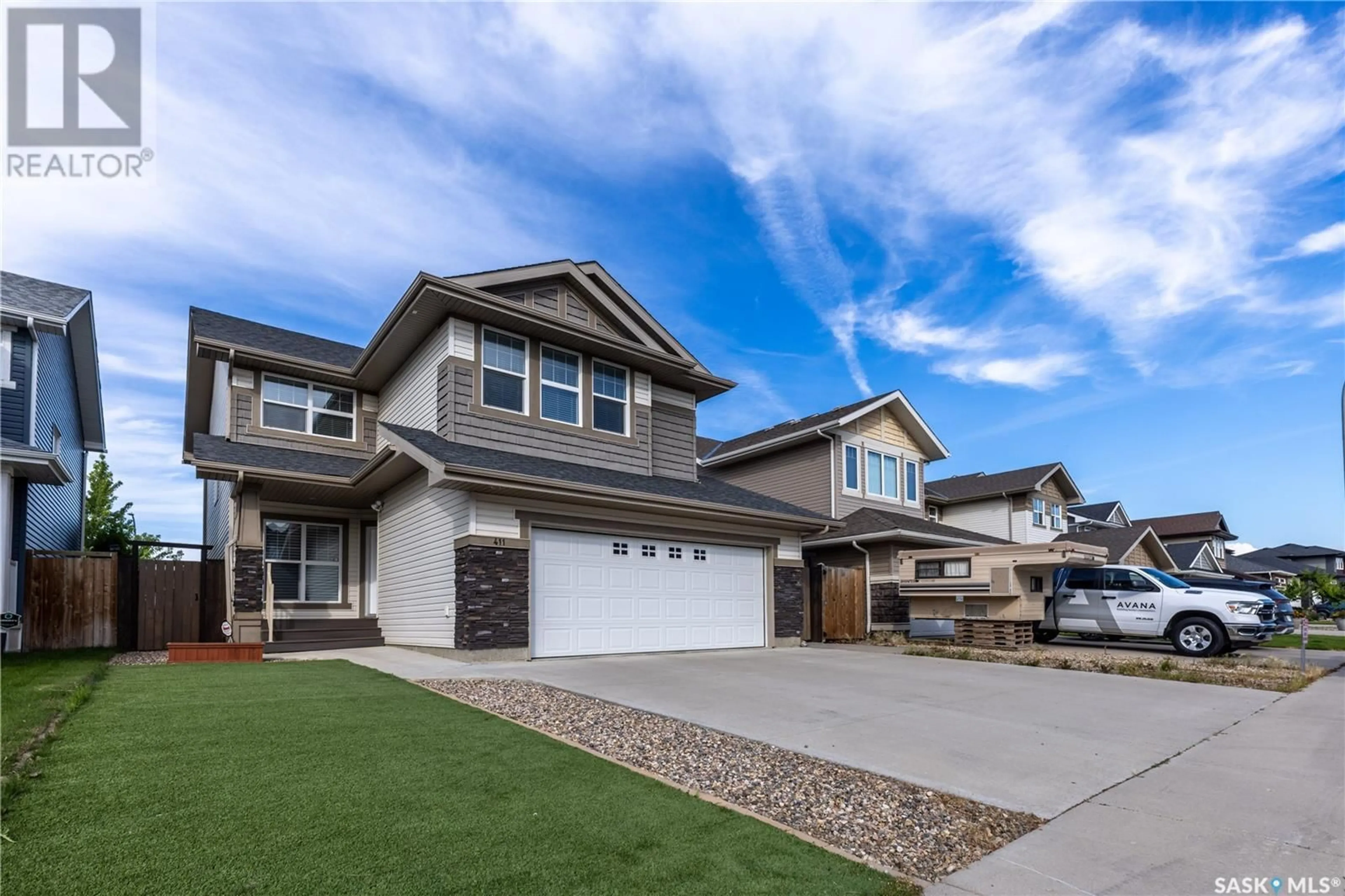 Home with vinyl exterior material, street for 411 FLYNN LANE, Saskatoon Saskatchewan S7V0L1