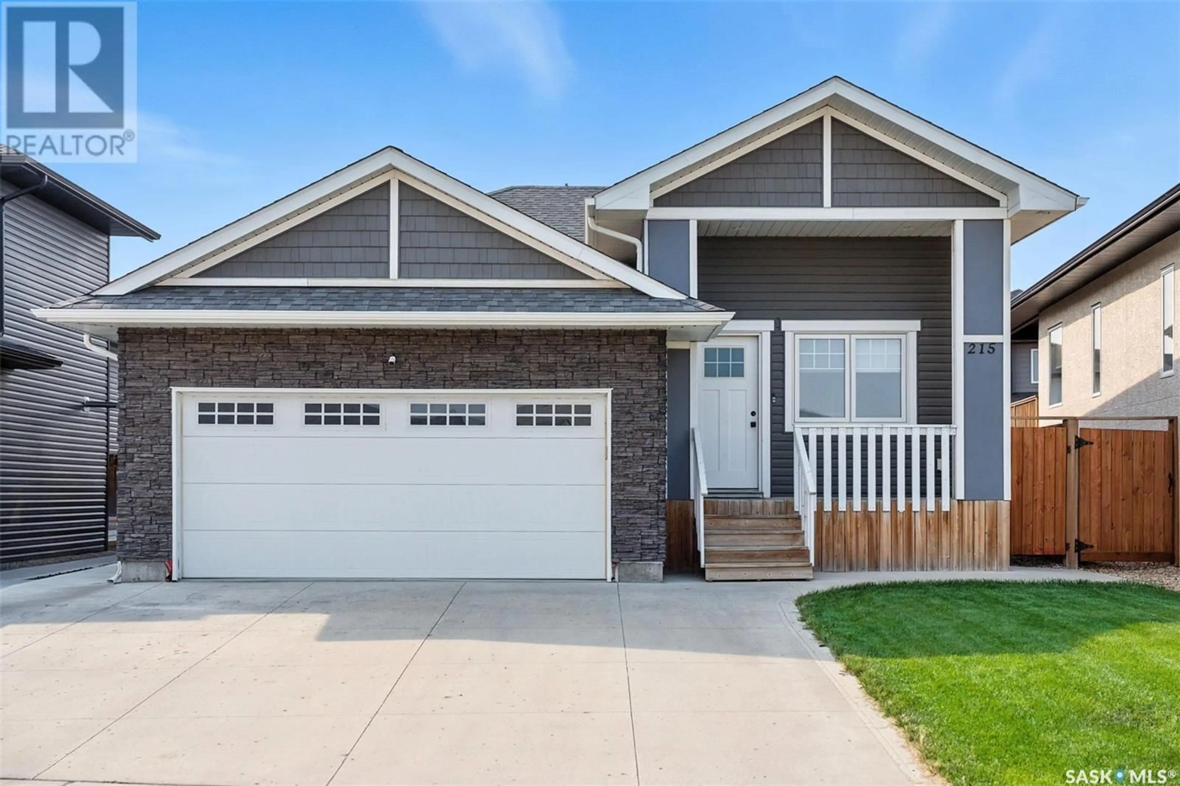 Home with vinyl exterior material, street for 215 BOLSTAD MANOR, Saskatoon Saskatchewan S7W0Y1