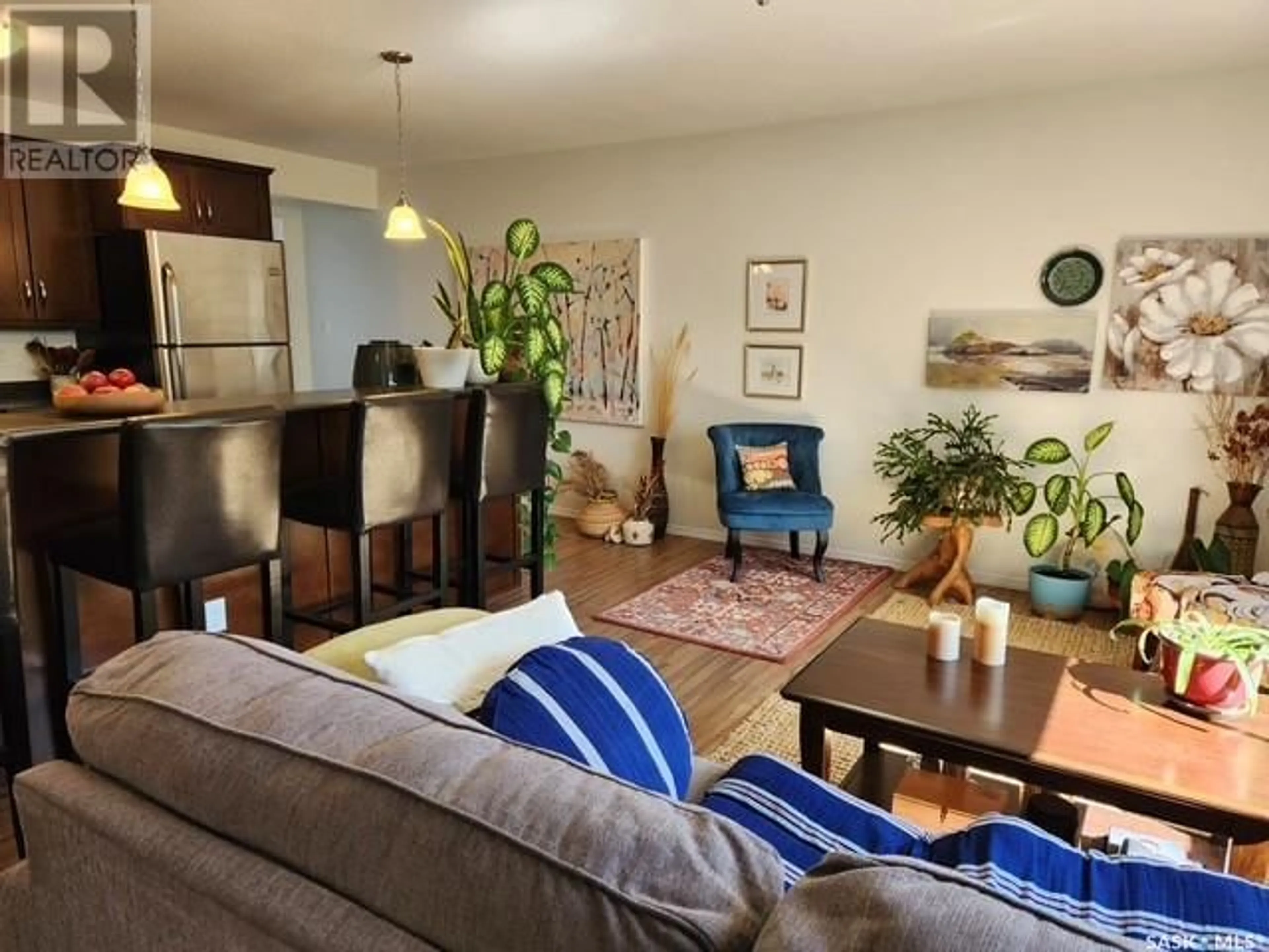 Living room with furniture, wood/laminate floor for 103 - 221 MAIN STREET, Moose Jaw Saskatchewan S6H2R4