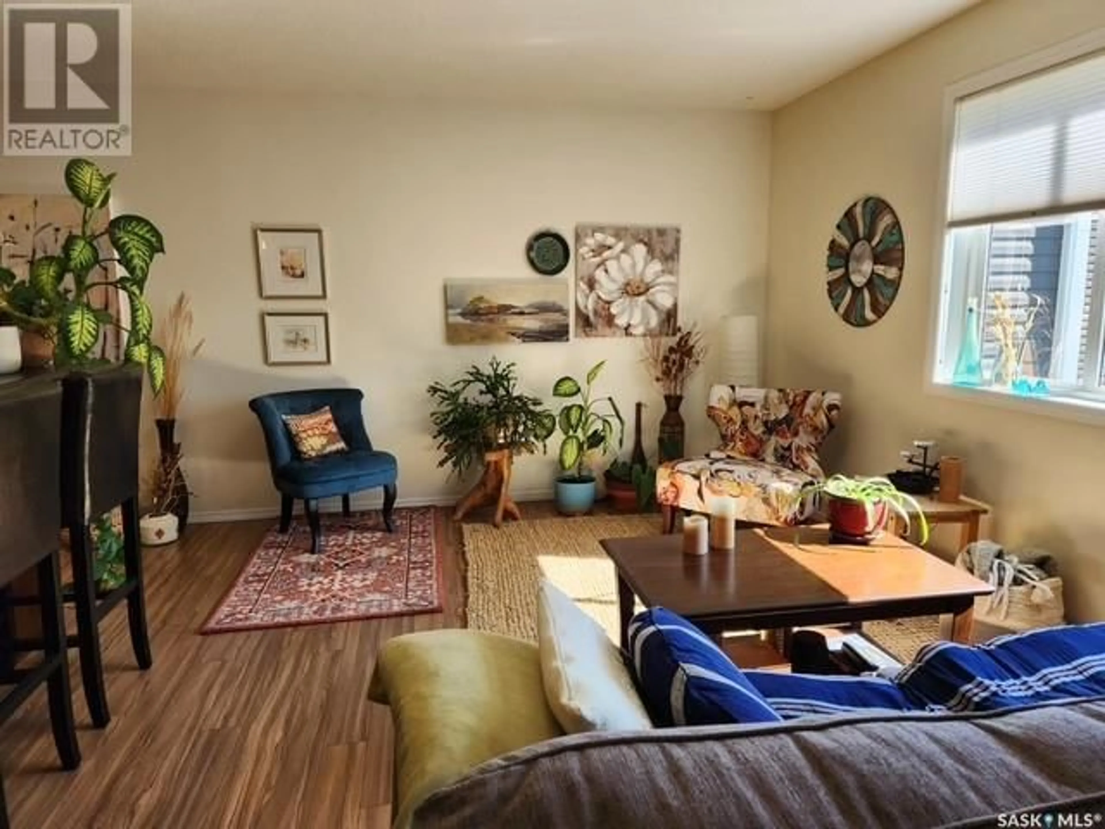 Living room with furniture, wood/laminate floor for 103 - 221 MAIN STREET, Moose Jaw Saskatchewan S6H2R4