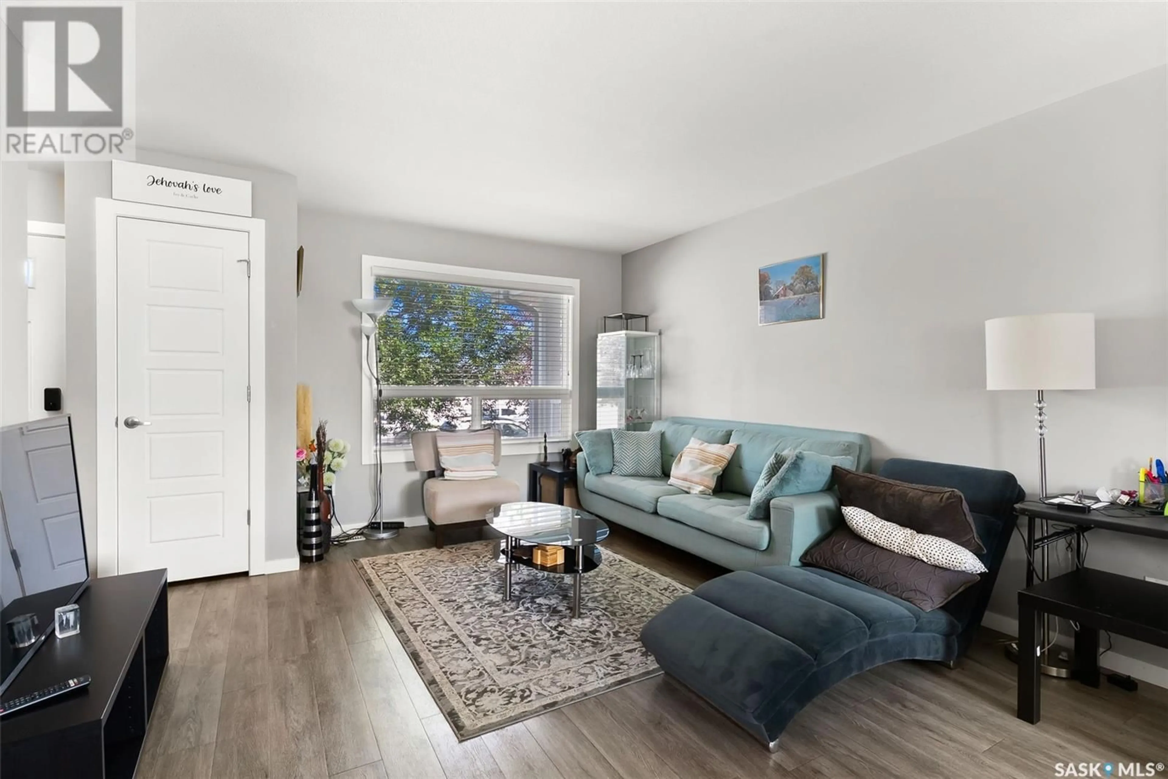 Living room with furniture, wood/laminate floor for 4621 PRIMROSE GREEN DRIVE, Regina Saskatchewan S4V3K4