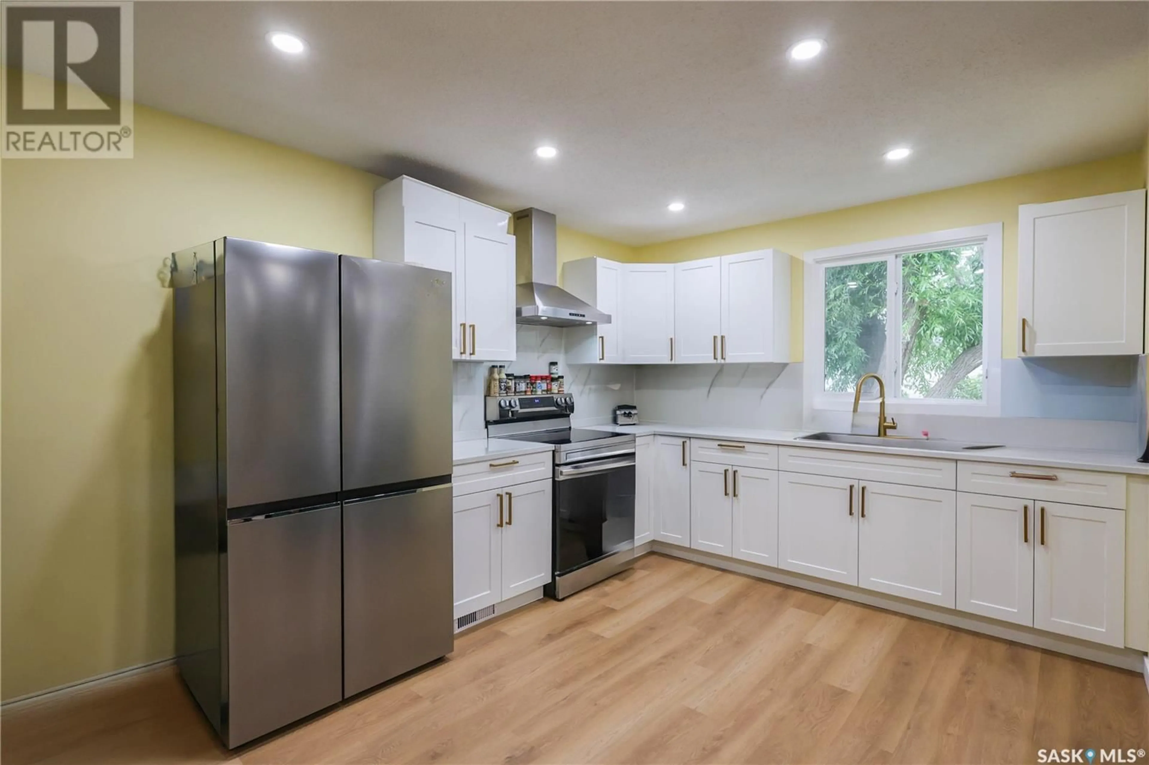 Open concept kitchen, wood/laminate floor for 16 KEMP CRESCENT, Prince Albert Saskatchewan S6V6H1