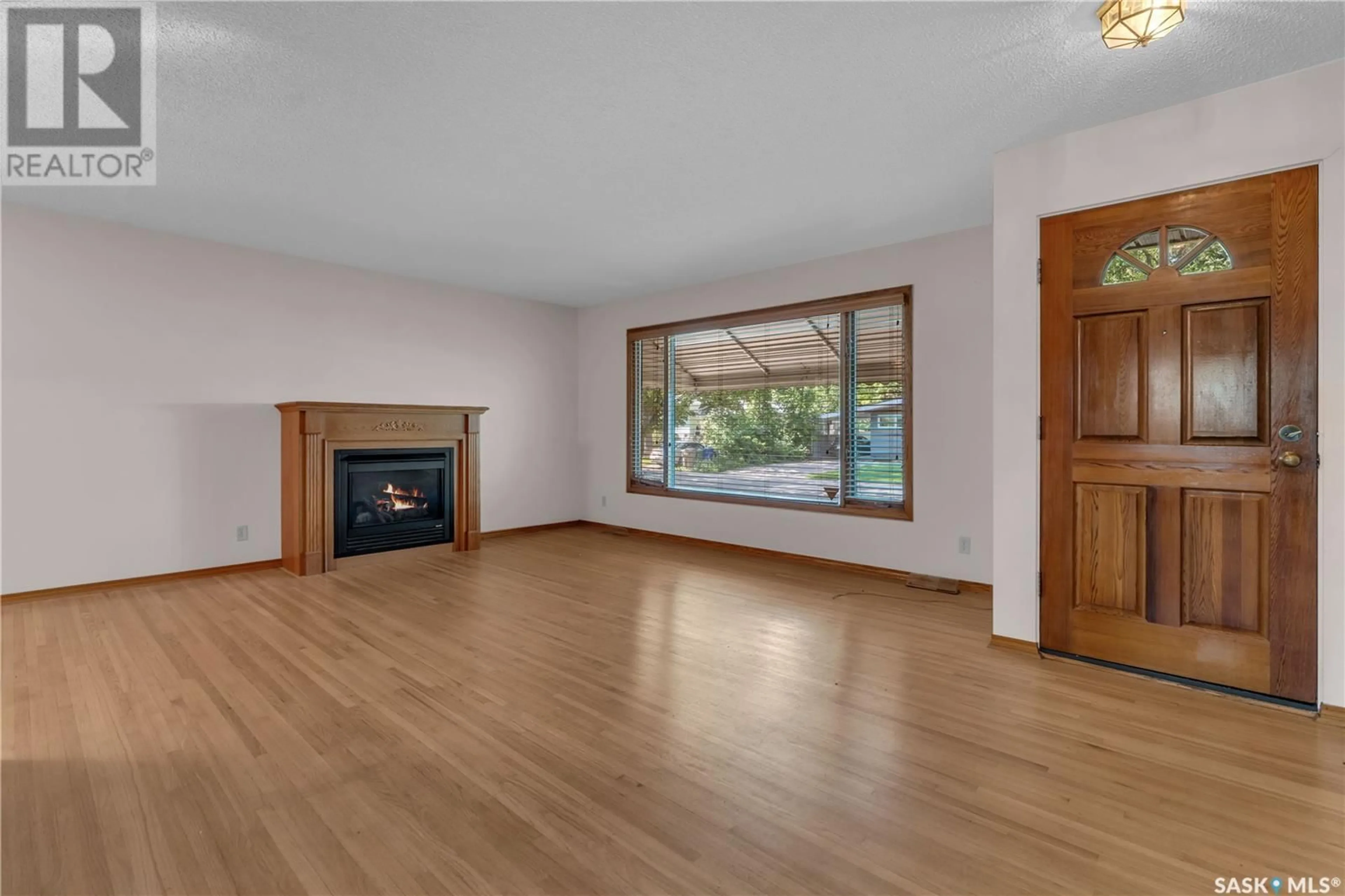 Living room with furniture, wood/laminate floor for 13 MARSH CRESCENT, Regina Saskatchewan S4S5R3