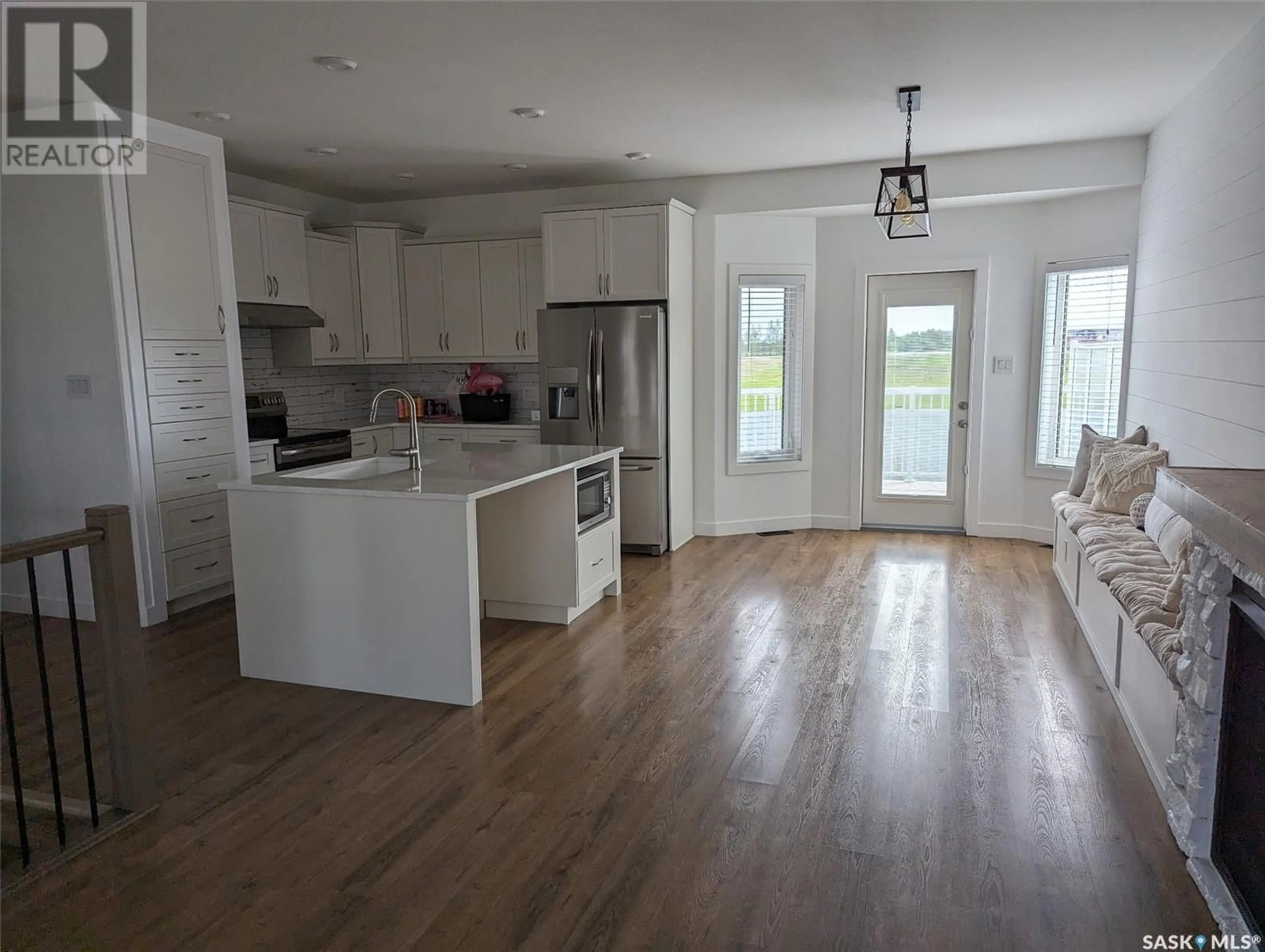 Open concept kitchen, wood/laminate floor for 804 1ST AVENUE, Warman Saskatchewan S0K4S2