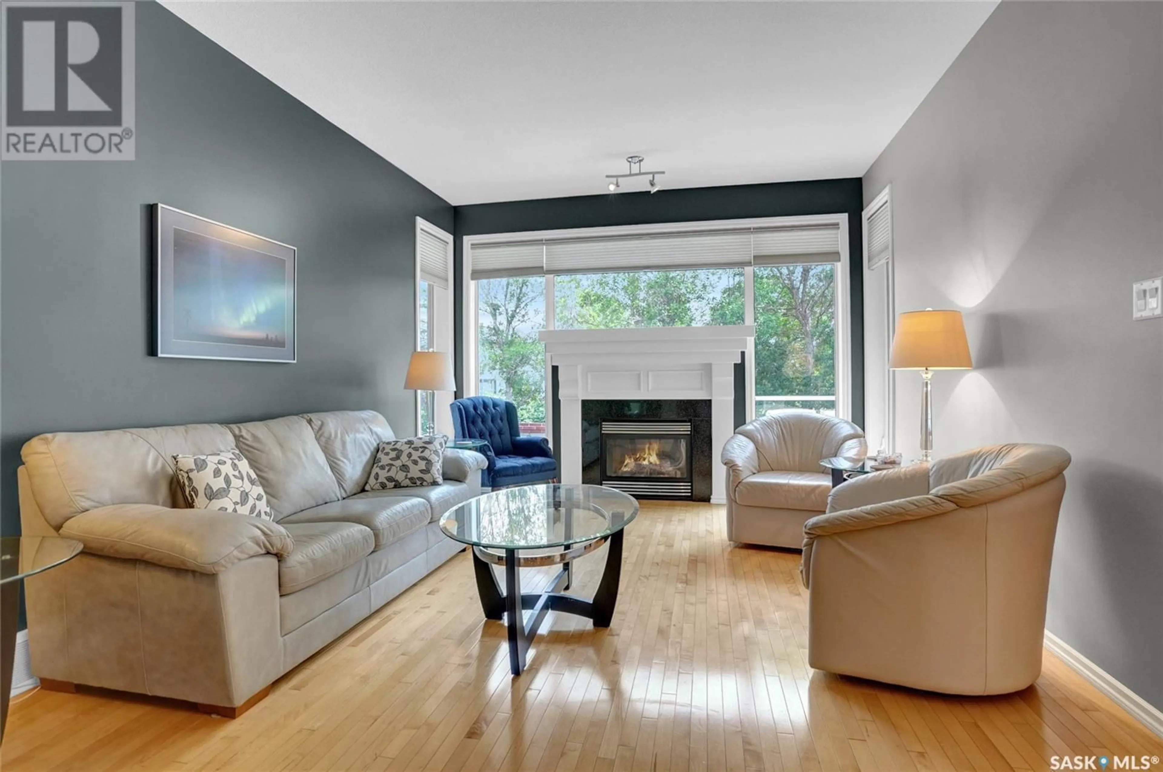 Living room with furniture, wood/laminate floor for 11108 WASCANA MEADOWS, Regina Saskatchewan S4V2W7