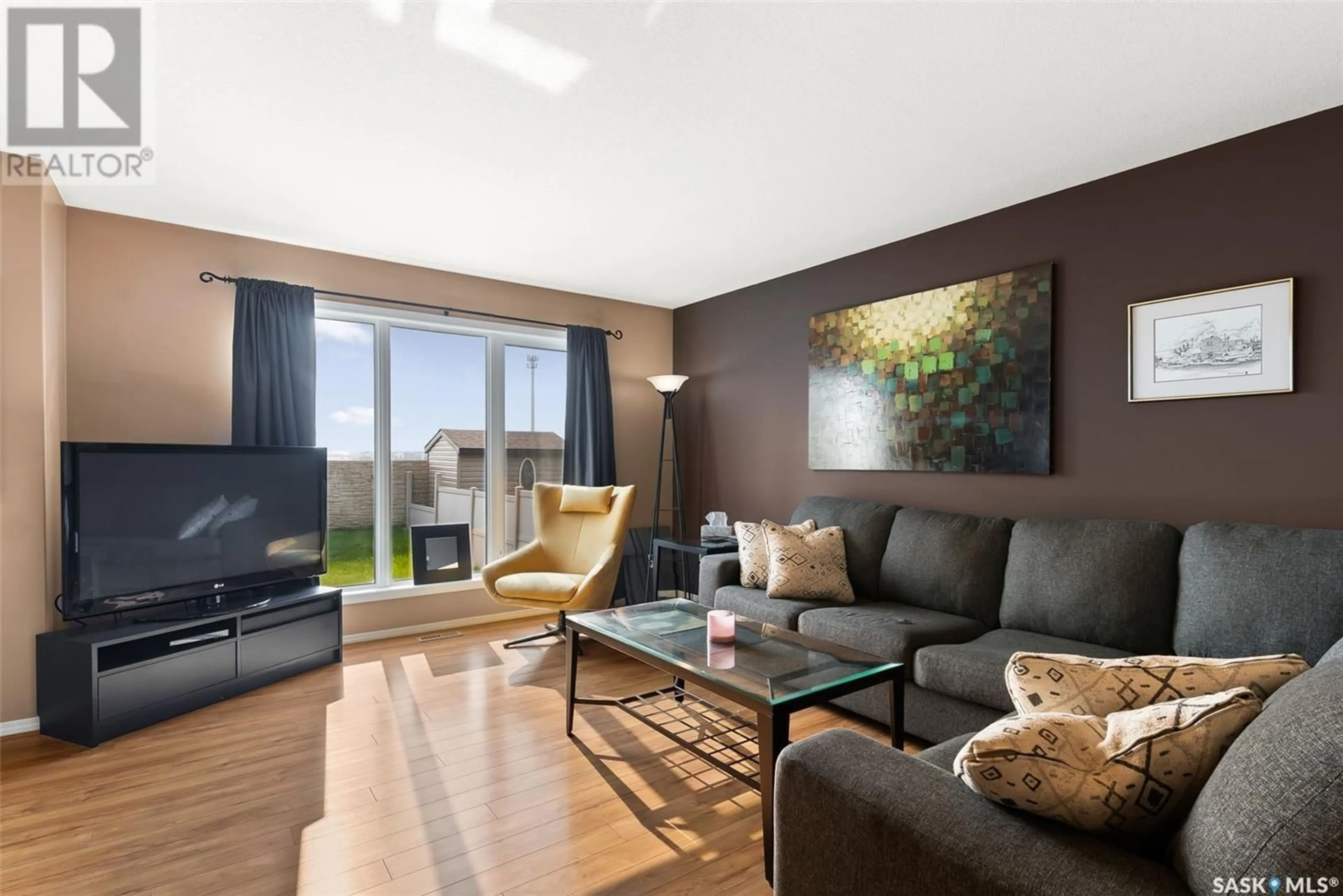 Living room with furniture, wood/laminate floor for 4331 NICUITY DRIVE, Regina Saskatchewan S4X0C1