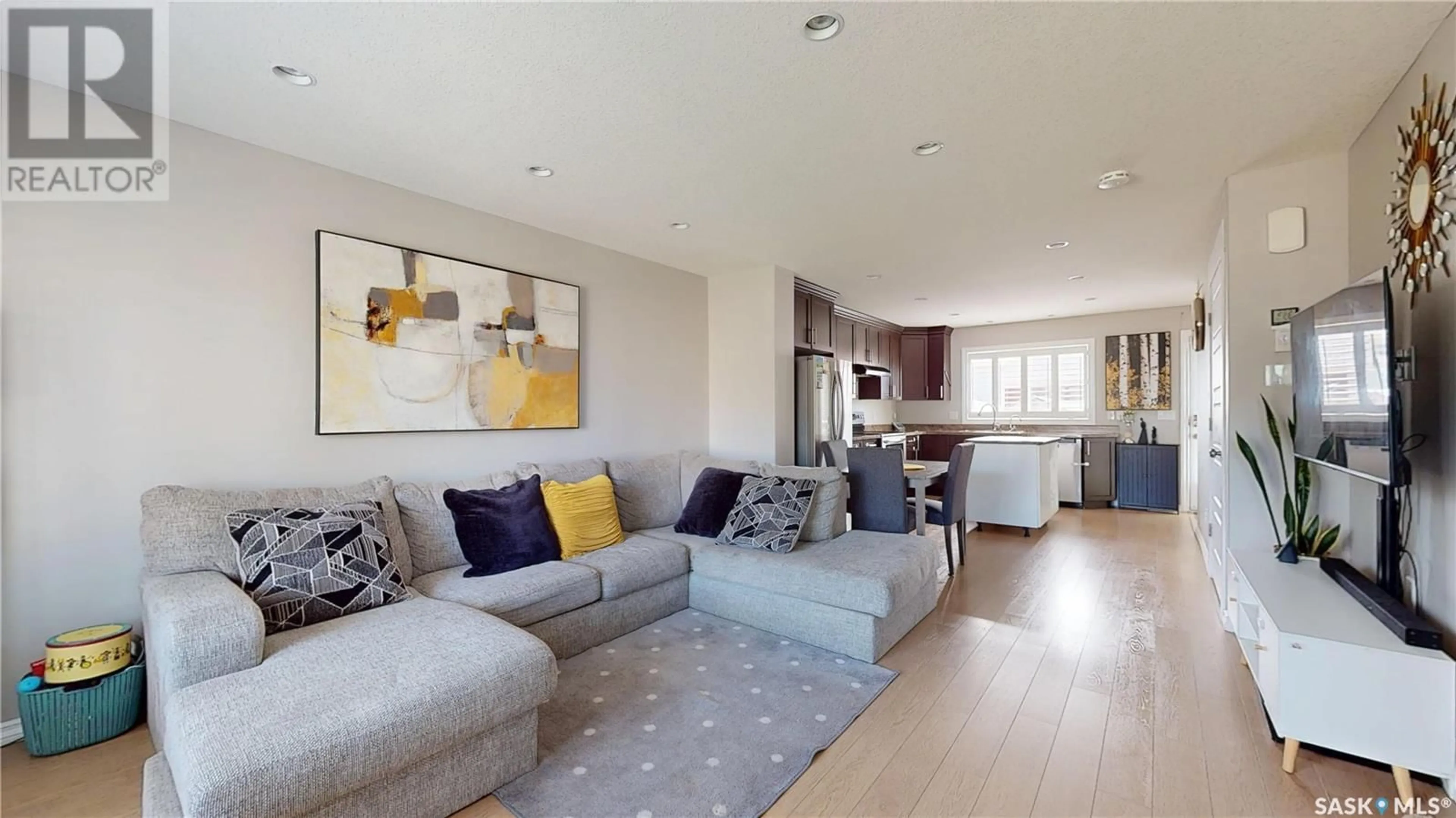 Living room with furniture, wood/laminate floor for 5237 JIM CAIRNS BOULEVARD, Regina Saskatchewan S4W0G7