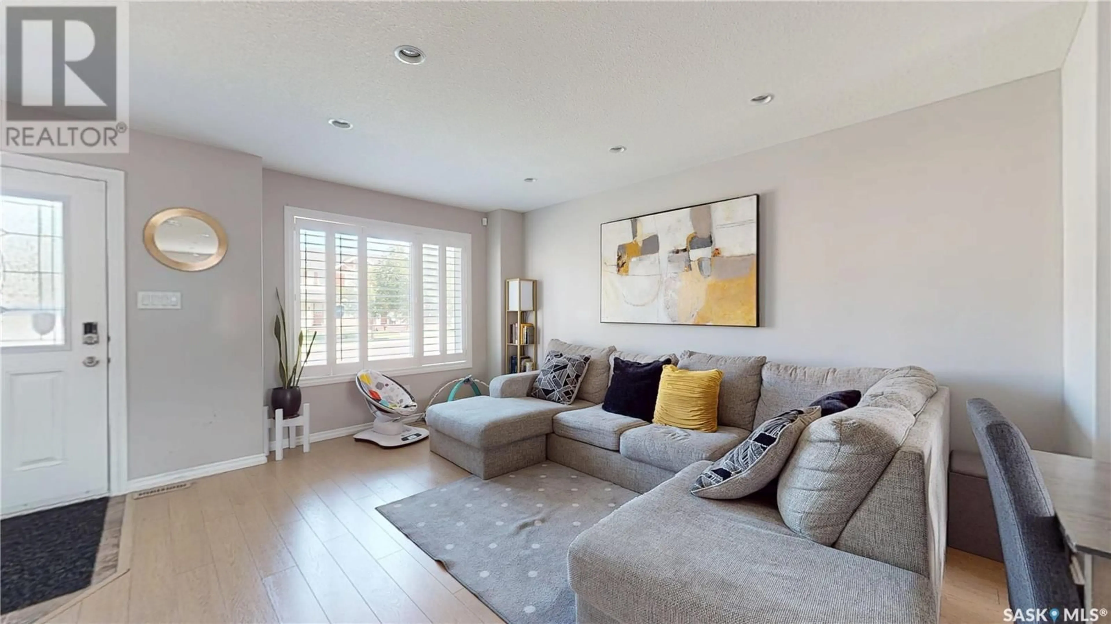 Living room with furniture, wood/laminate floor for 5237 JIM CAIRNS BOULEVARD, Regina Saskatchewan S4W0G7