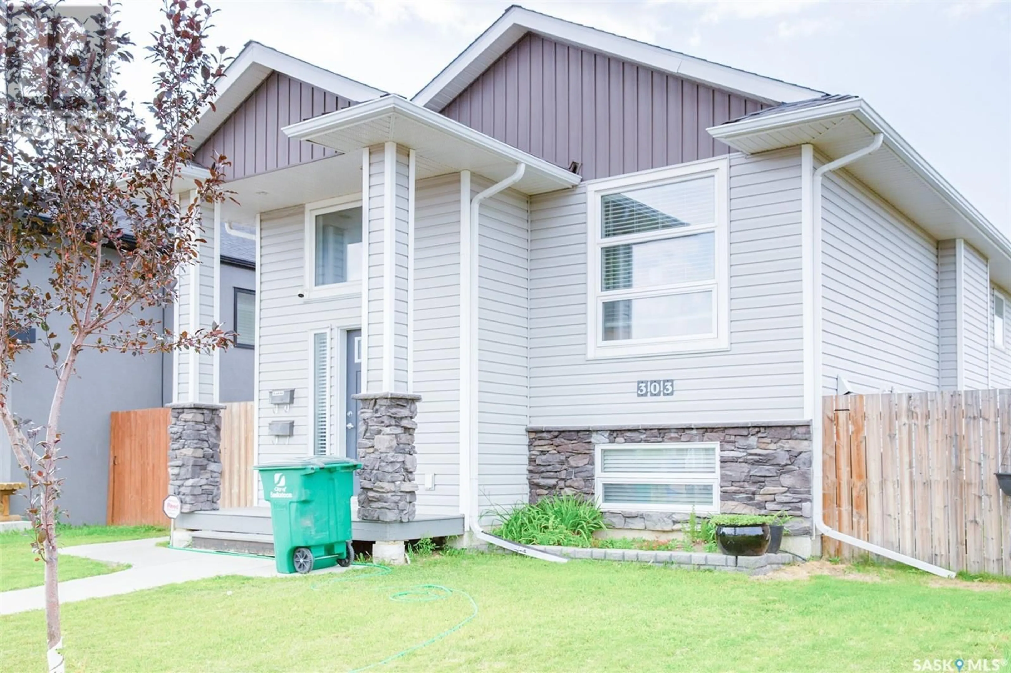 Home with vinyl exterior material, street for 303 ROSEWOOD BOULEVARD, Saskatoon Saskatchewan S7V0G8