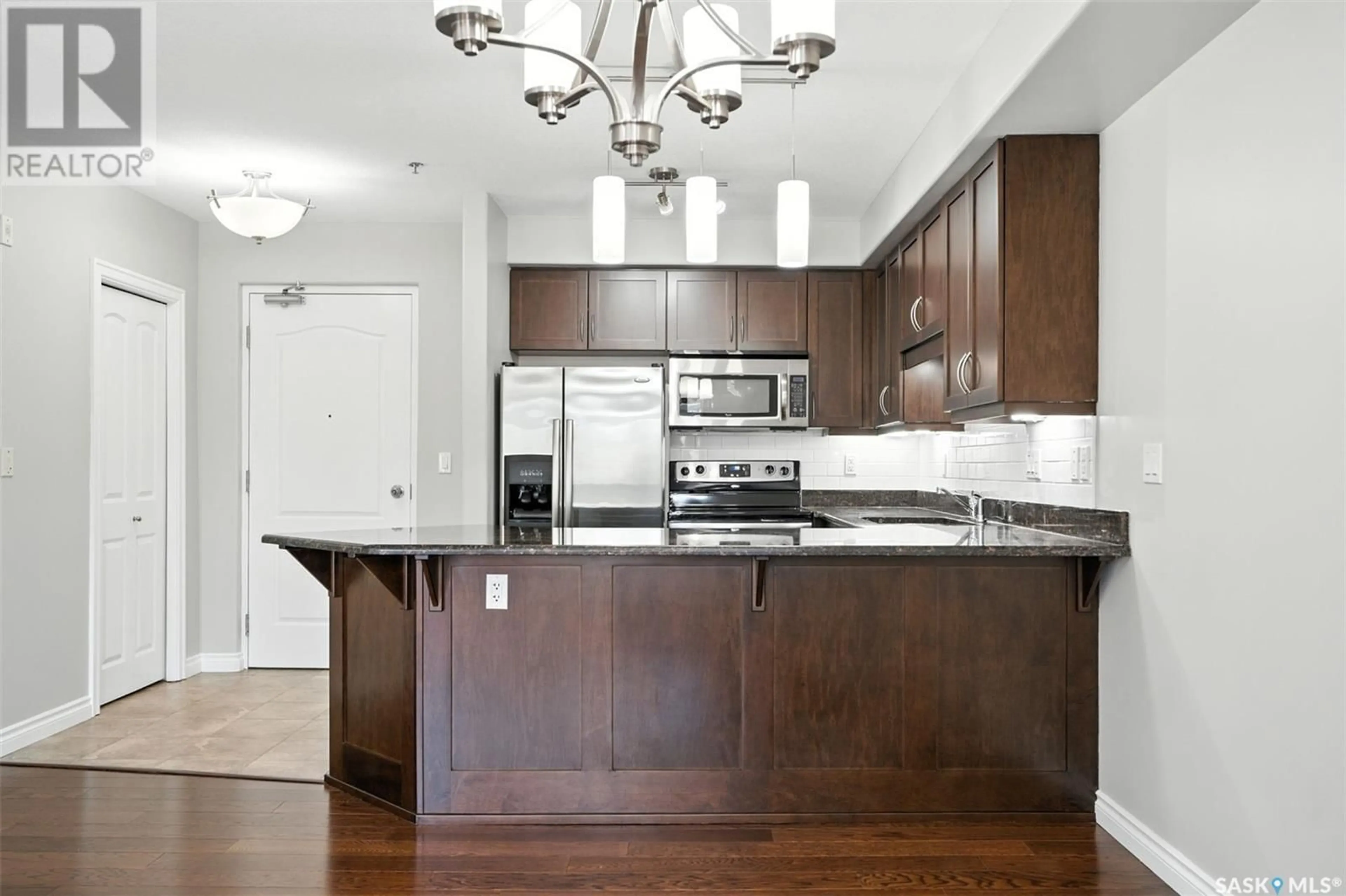 Open concept kitchen, wood/laminate floor for 227 - 105 PINEHOUSE DRIVE, Saskatoon Saskatchewan S7K6N9