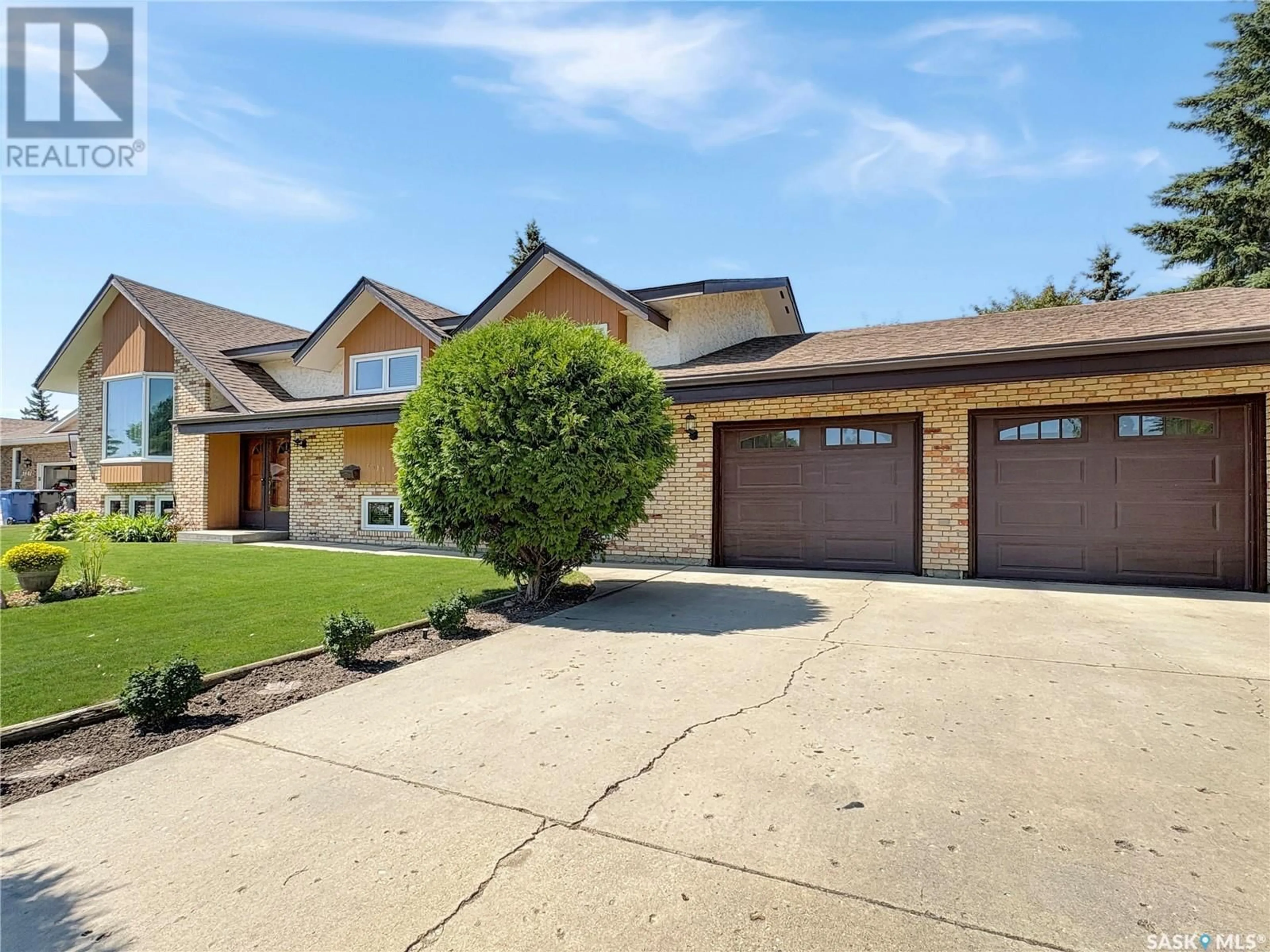 Home with brick exterior material, street for 2411 MEADOW LARK LANE, North Battleford Saskatchewan S9A3V1