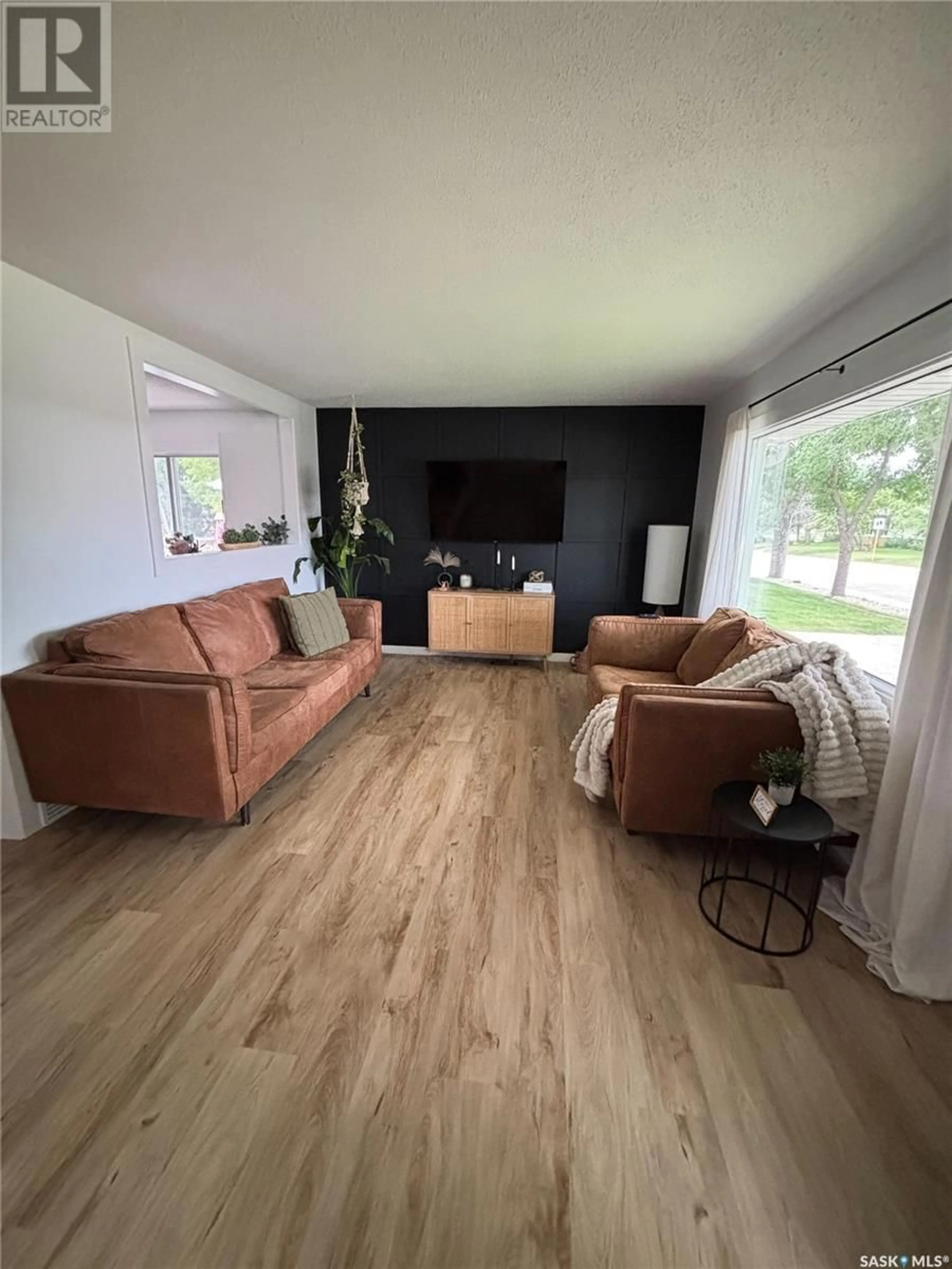 Living room with furniture, wood/laminate floor for 1843 GIBBS ROAD, Estevan Saskatchewan S4A1Y1