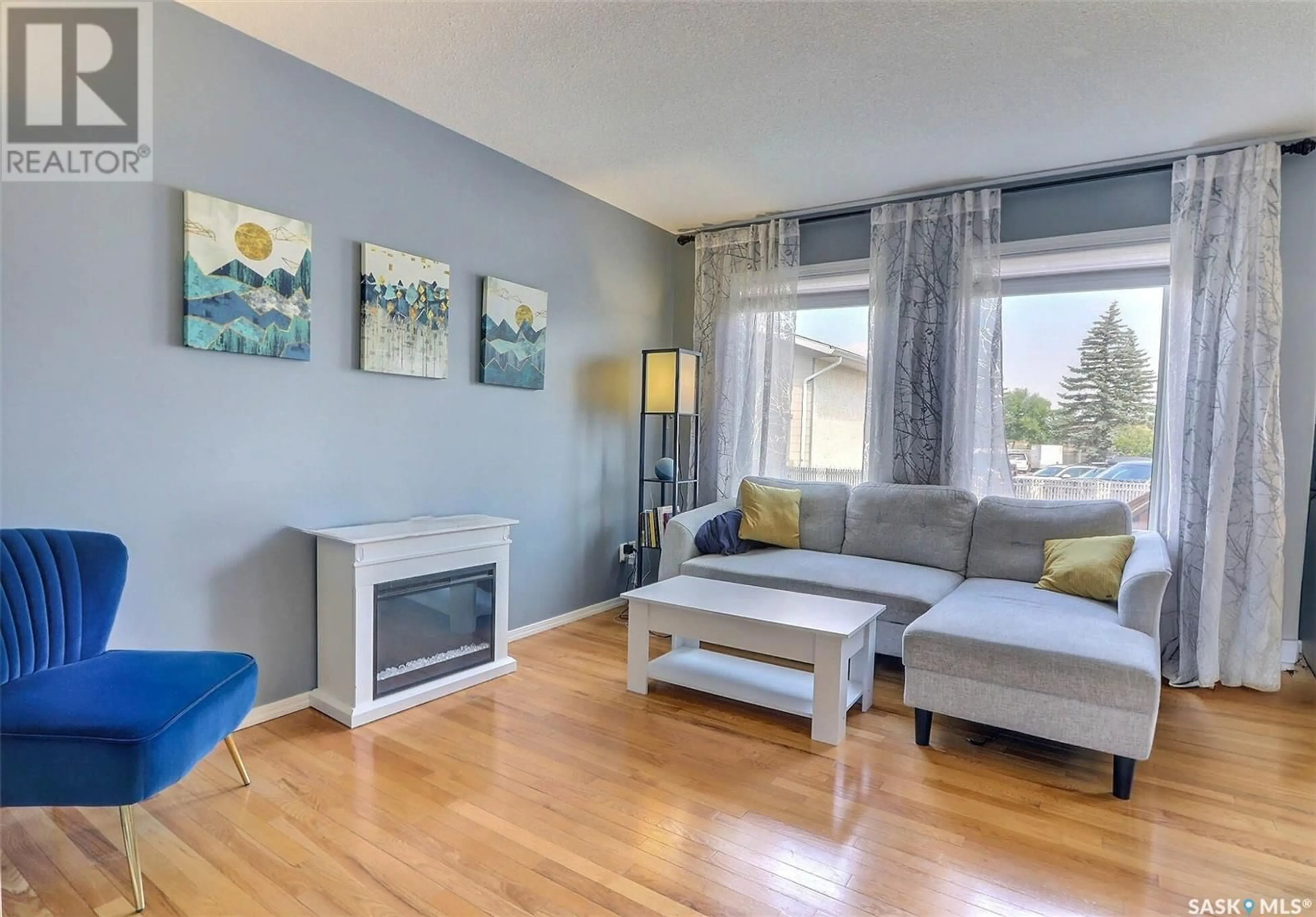 Living room with furniture, wood/laminate floor for 16 - 1620 OLIVE DIEFENBAKER DRIVE, Prince Albert Saskatchewan S6V1C5