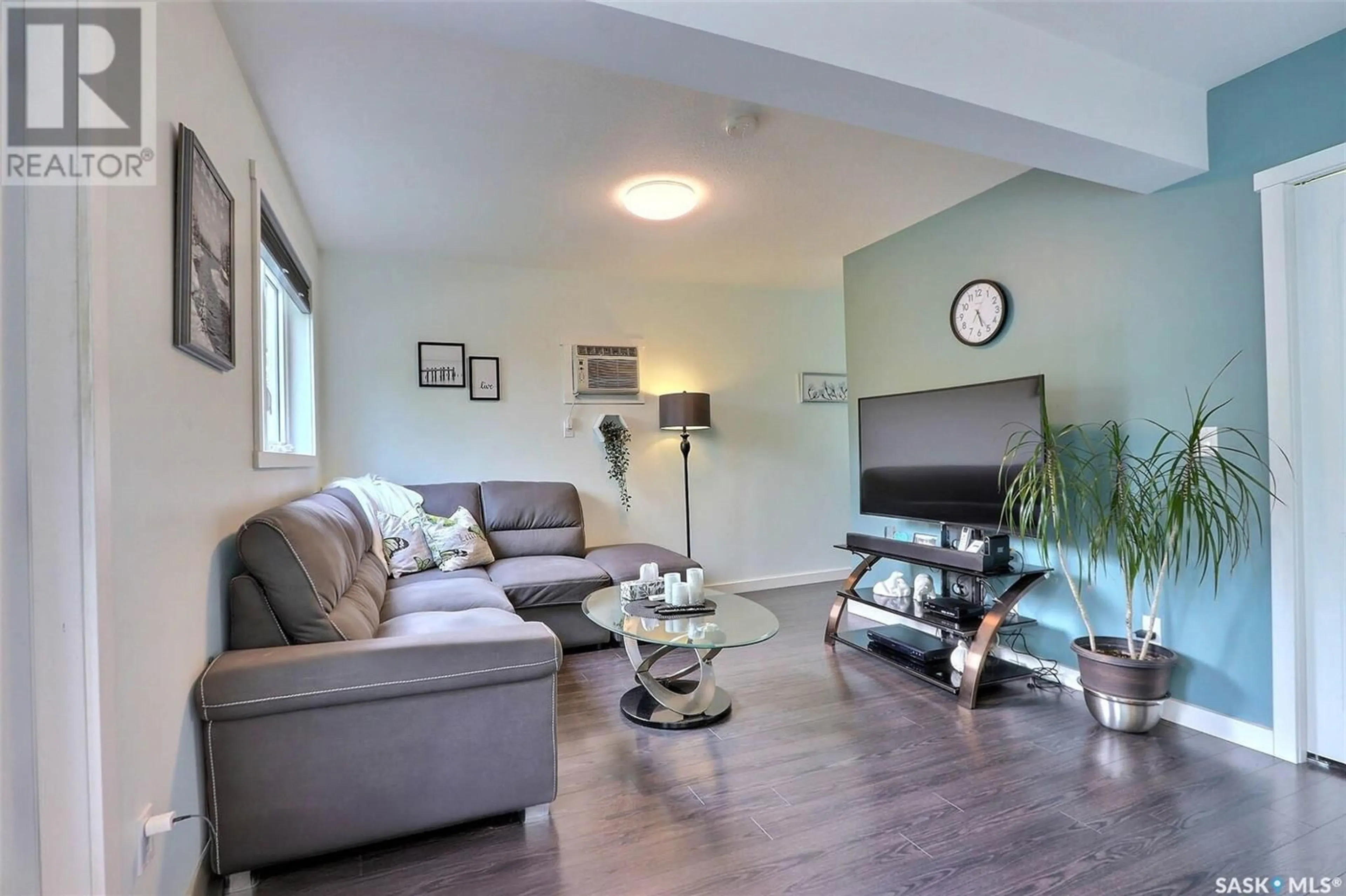Living room with furniture, wood/laminate floor for 554 22ND STREET, Prince Albert Saskatchewan S6V1N7