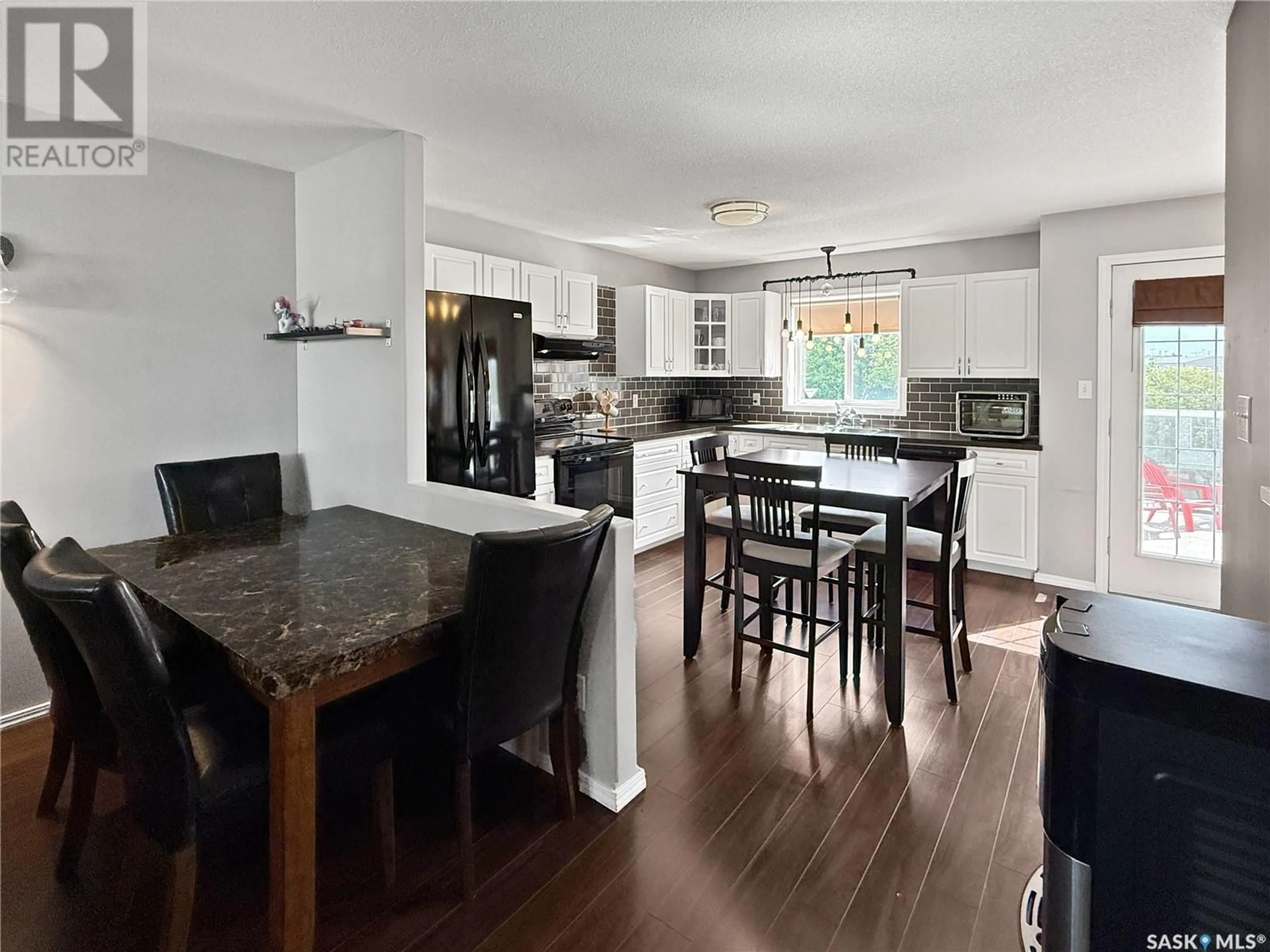 Open concept kitchen, wood/laminate floor for 235 SOUTHWOOD DRIVE, Prince Albert Saskatchewan S6V8E7