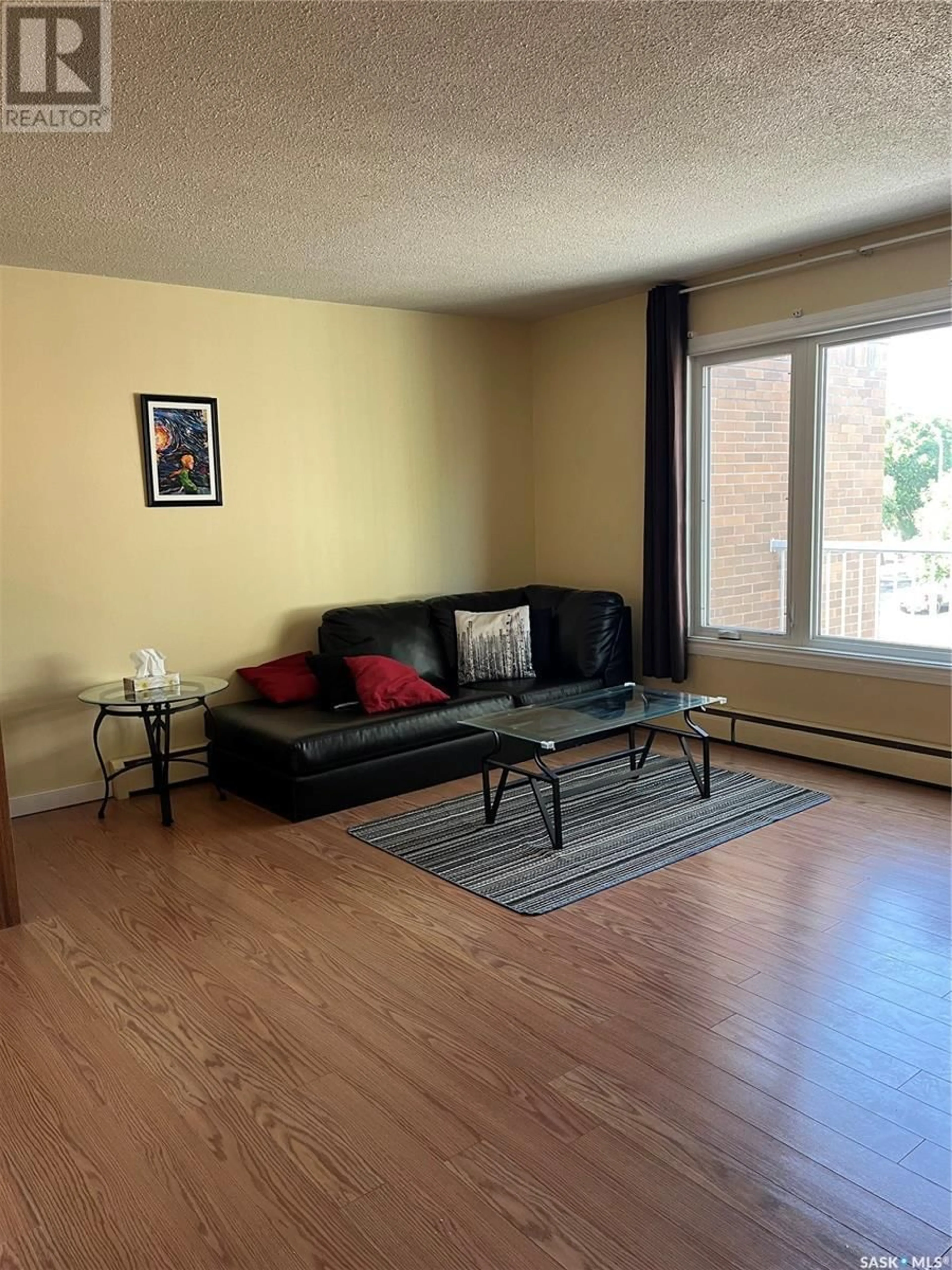 Living room with furniture, wood/laminate floor for 20 - 4505 RAE STREET, Regina Saskatchewan S4S3B2