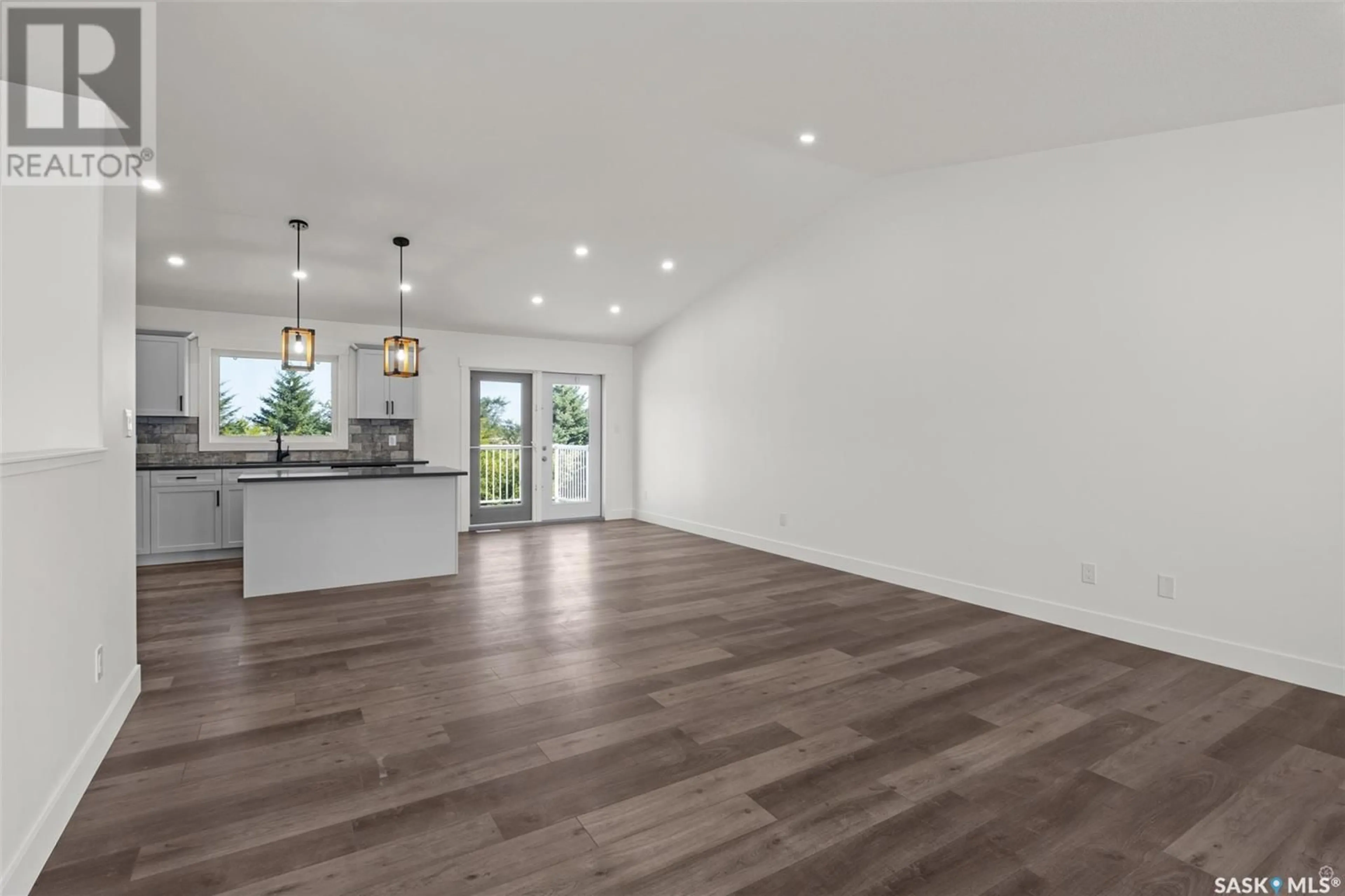 Open concept kitchen, wood/laminate floor for 216 KESTREL COURT, Rosthern Saskatchewan S0K3R0