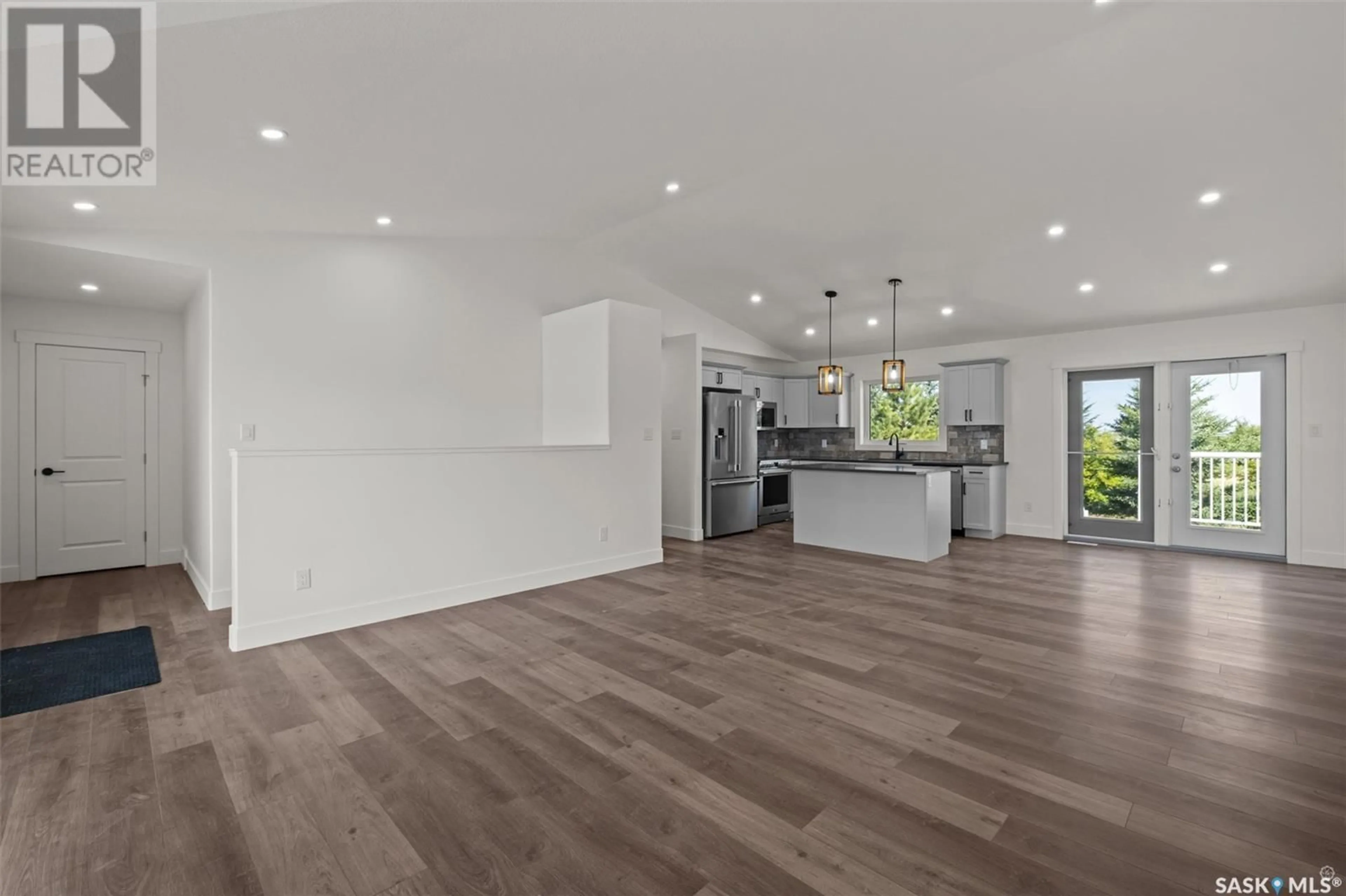 Open concept kitchen, wood/laminate floor for 216 KESTREL COURT, Rosthern Saskatchewan S0K3R0