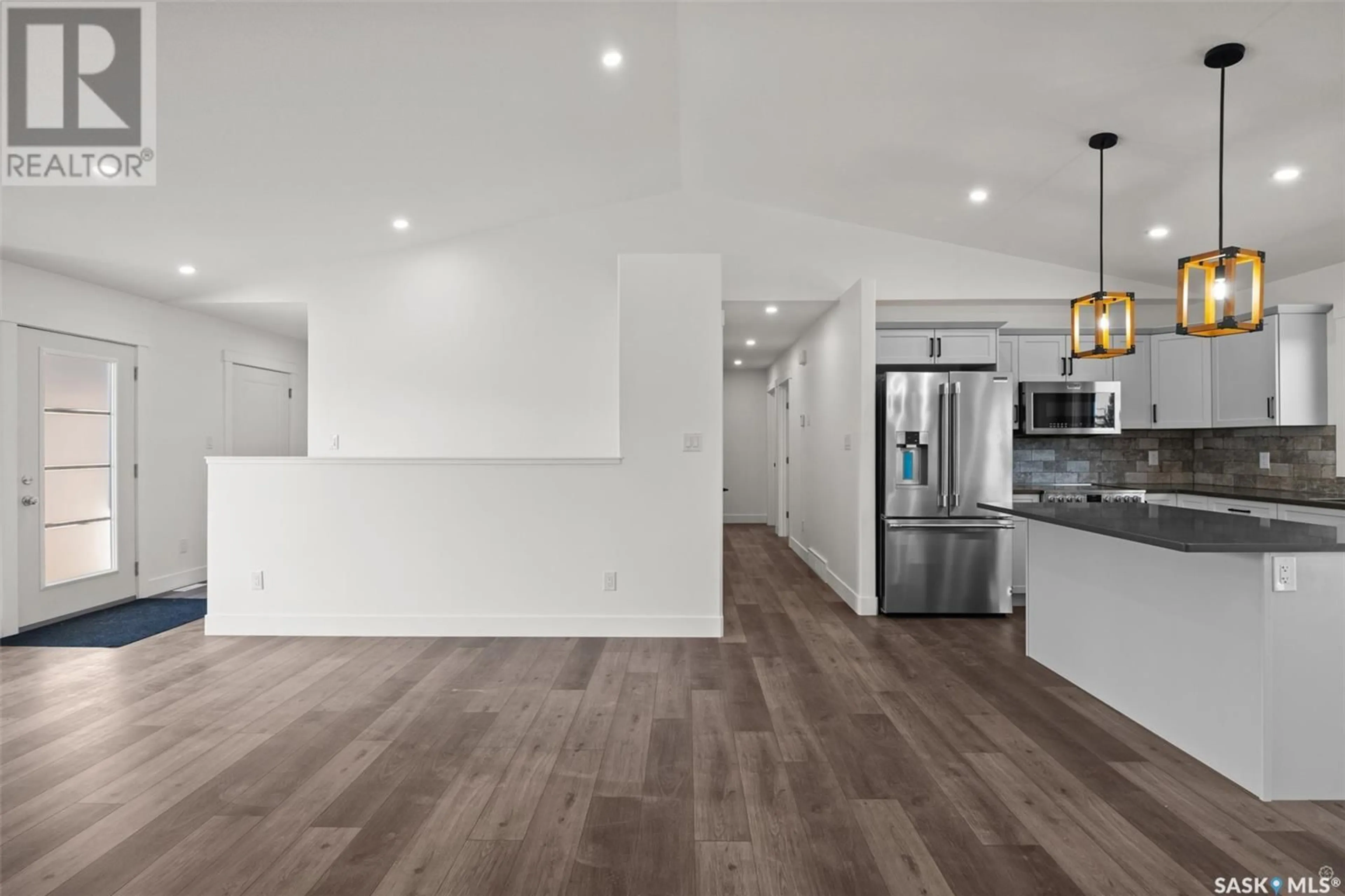 Open concept kitchen, wood/laminate floor for 216 KESTREL COURT, Rosthern Saskatchewan S0K3R0