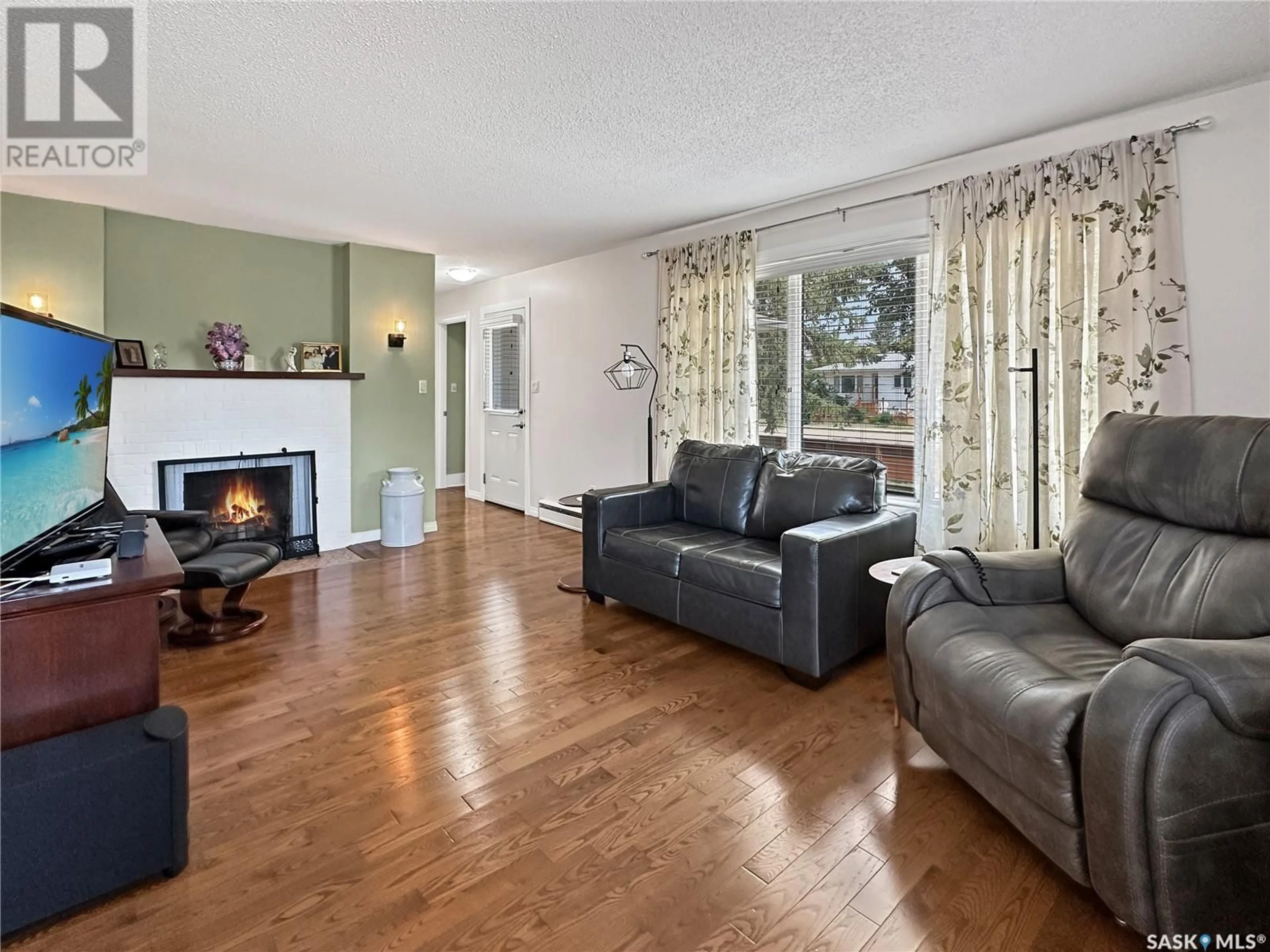 Living room with furniture, wood/laminate floor for 614 GODKIN AVENUE, Balcarres Saskatchewan S0G0C0
